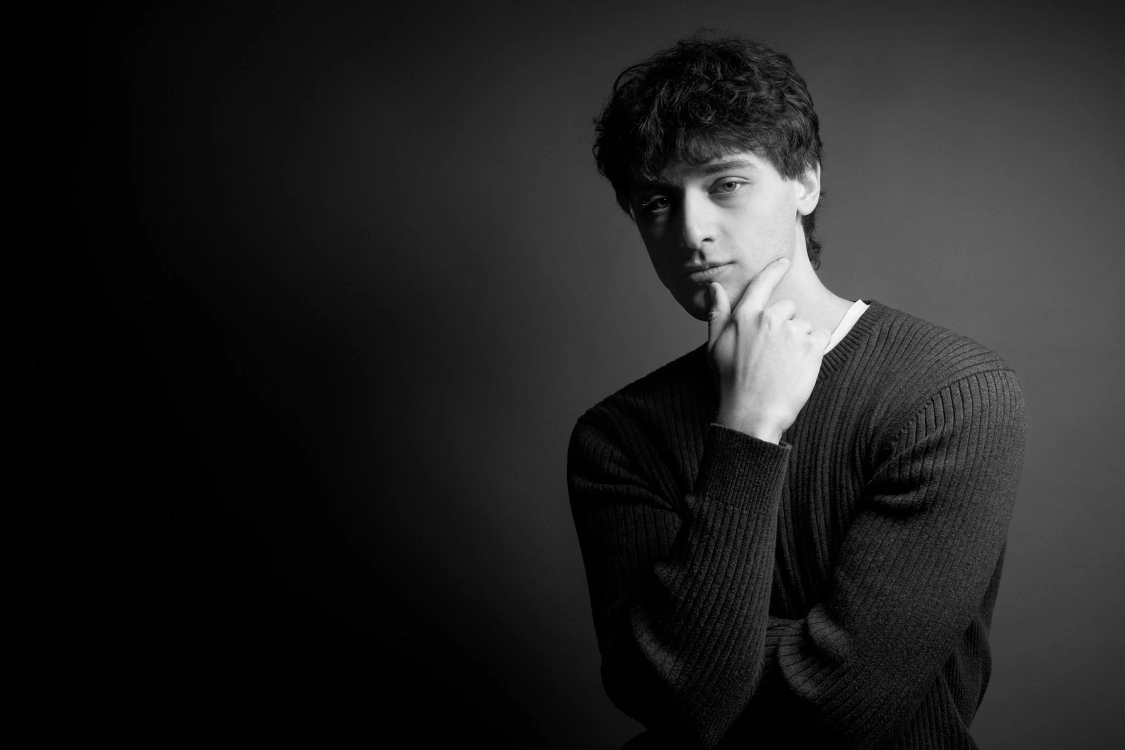 Black and white portrait of a man with hand on chin, thoughtful expression, photographed in Concord Massachusetts