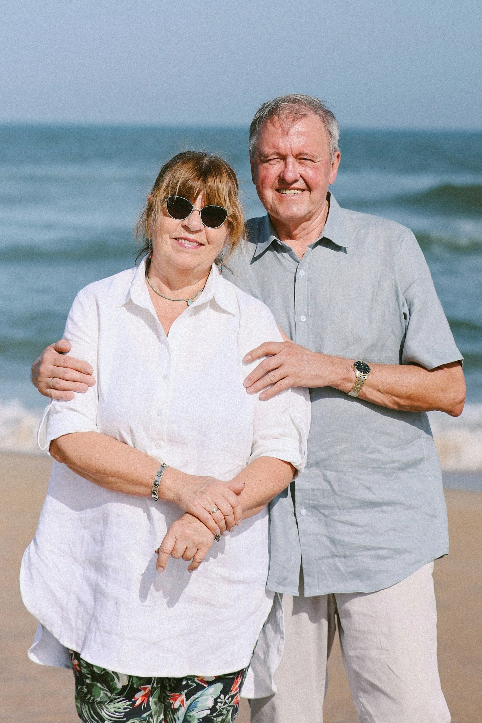 A young man with blonde hair and blue eyes taking a selfie outdoors with his dog on a sunny day, both smiling.