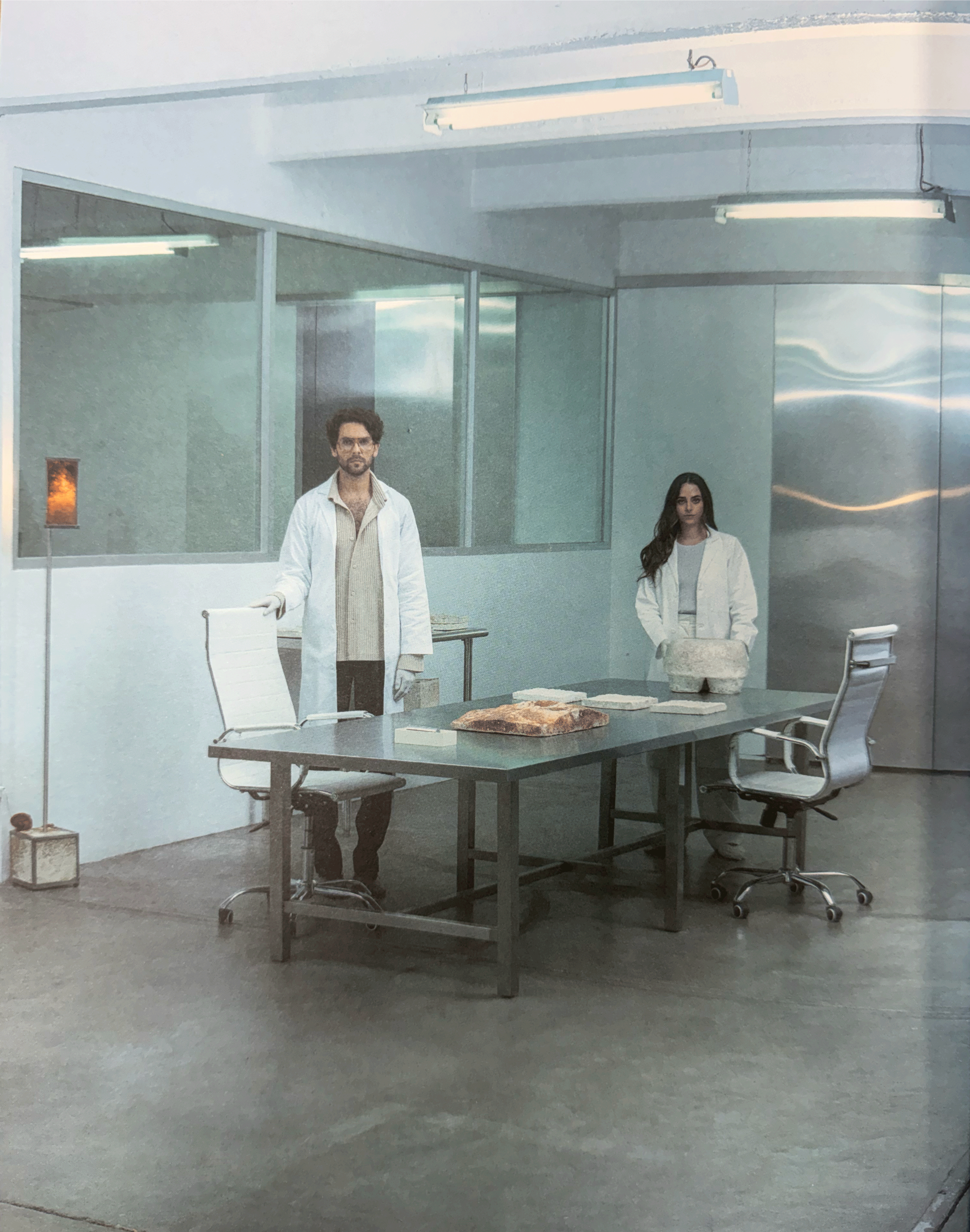 Monterr co-founders, María Monteys and Federico Herrera, inside Monterr's biomaterials lab, standing by a table with mycelium samples for sustainable packaging and design research.