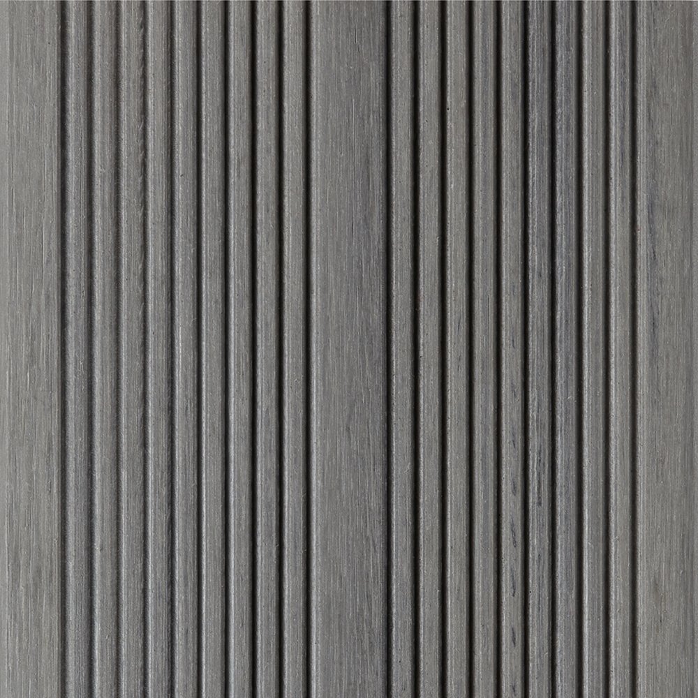 Close-up view of a textured, dark gray, wooden surface with vertical grooves
