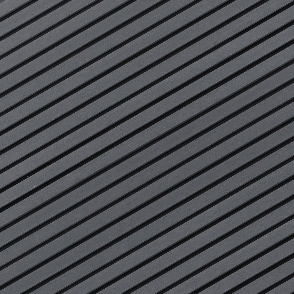 Close-up of a surface with diagonal black and gray ridges.