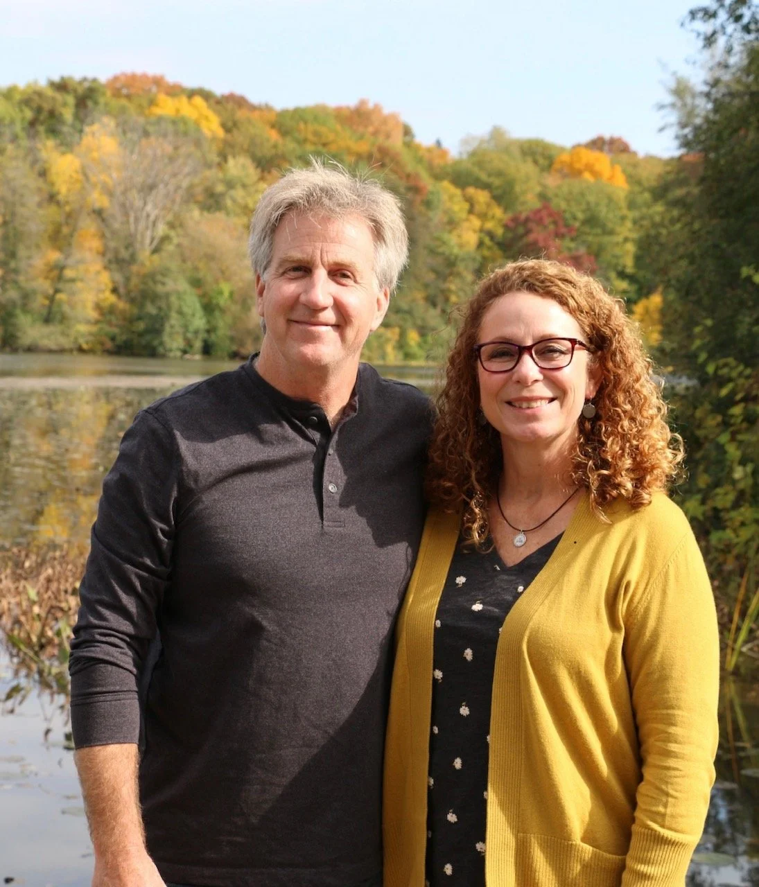 Mackenzie Building Company owner John Mackenzie with wife Laura, pictured in front of a lake in Michigan in autumn