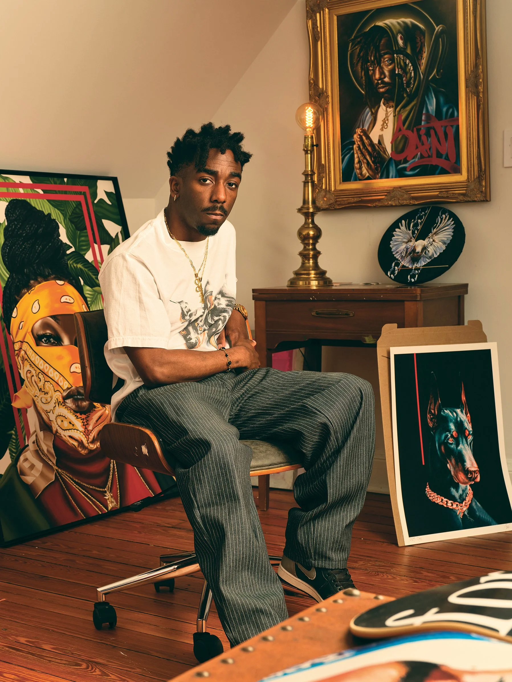 Environmental portrait of Baltimore artist G Pack in his studio surrounded by his original artwork and designs.