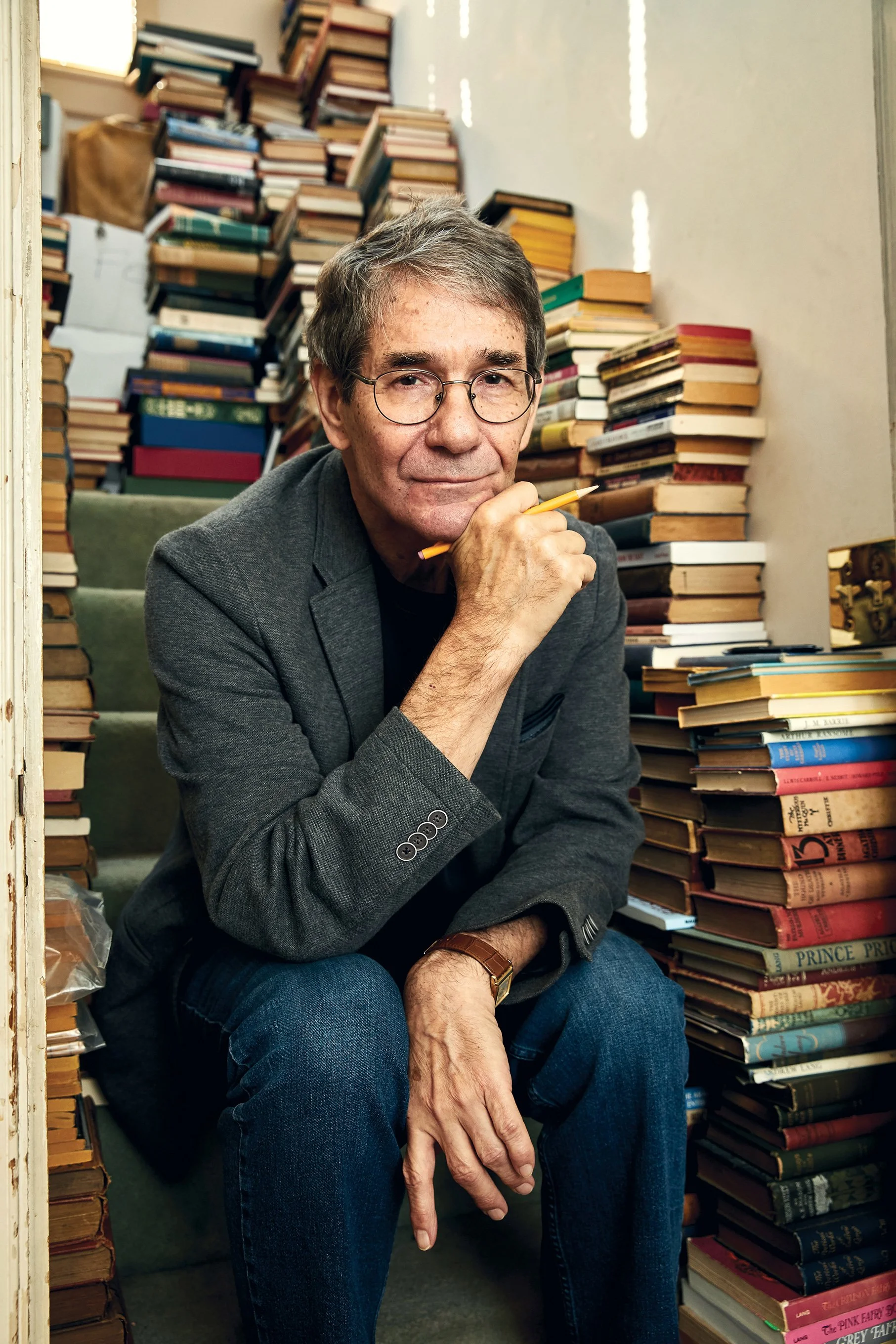 Editorial portrait of Pulitzer Prize-winning columnist Michael Dirda in his home surrounded by books, photographed for Bethesda Magazine.
