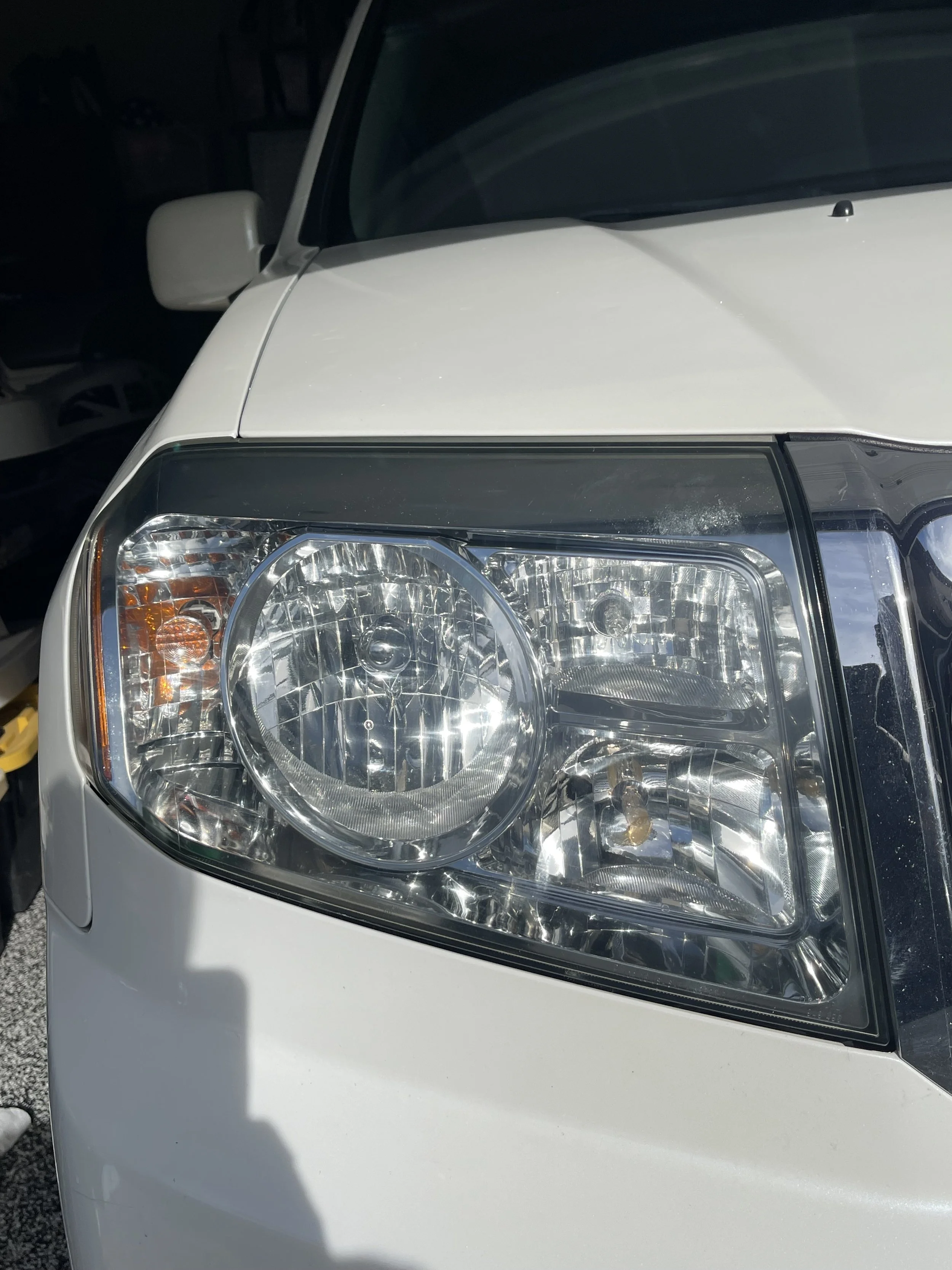 Headlight restored to a crystal-clear, like-new finish with improved clarity, shine, and light output.