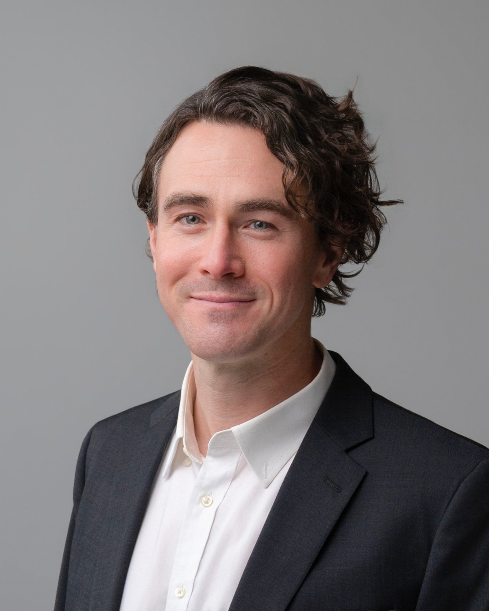 Circular professional headshot of Dr. Brian Clear