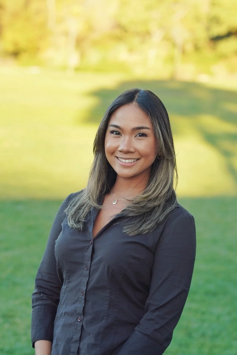 Jenny Seradilla, LMFT, smiling in a professional outdoor headshot.