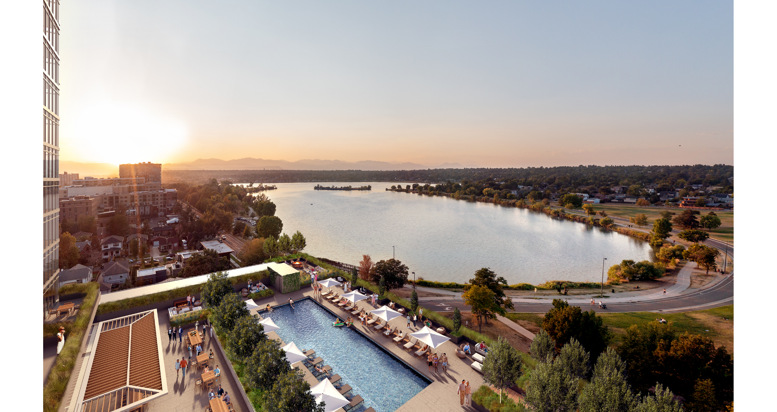 River with green banks and distant mountains, view from a high-rise balcony showing a rooftop pool area with lounge chairs, umbrellas, and people, during sunset.