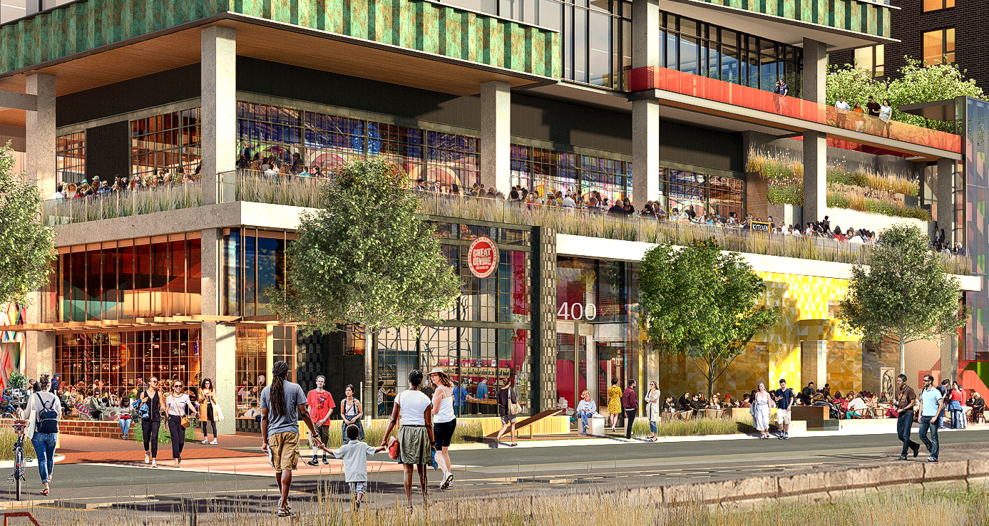 A modern multi-story building with glass walls and open balconies, filled with people dining and socializing. The ground level has shops and outdoor seating areas, with trees and pedestrians on the sidewalk in front.