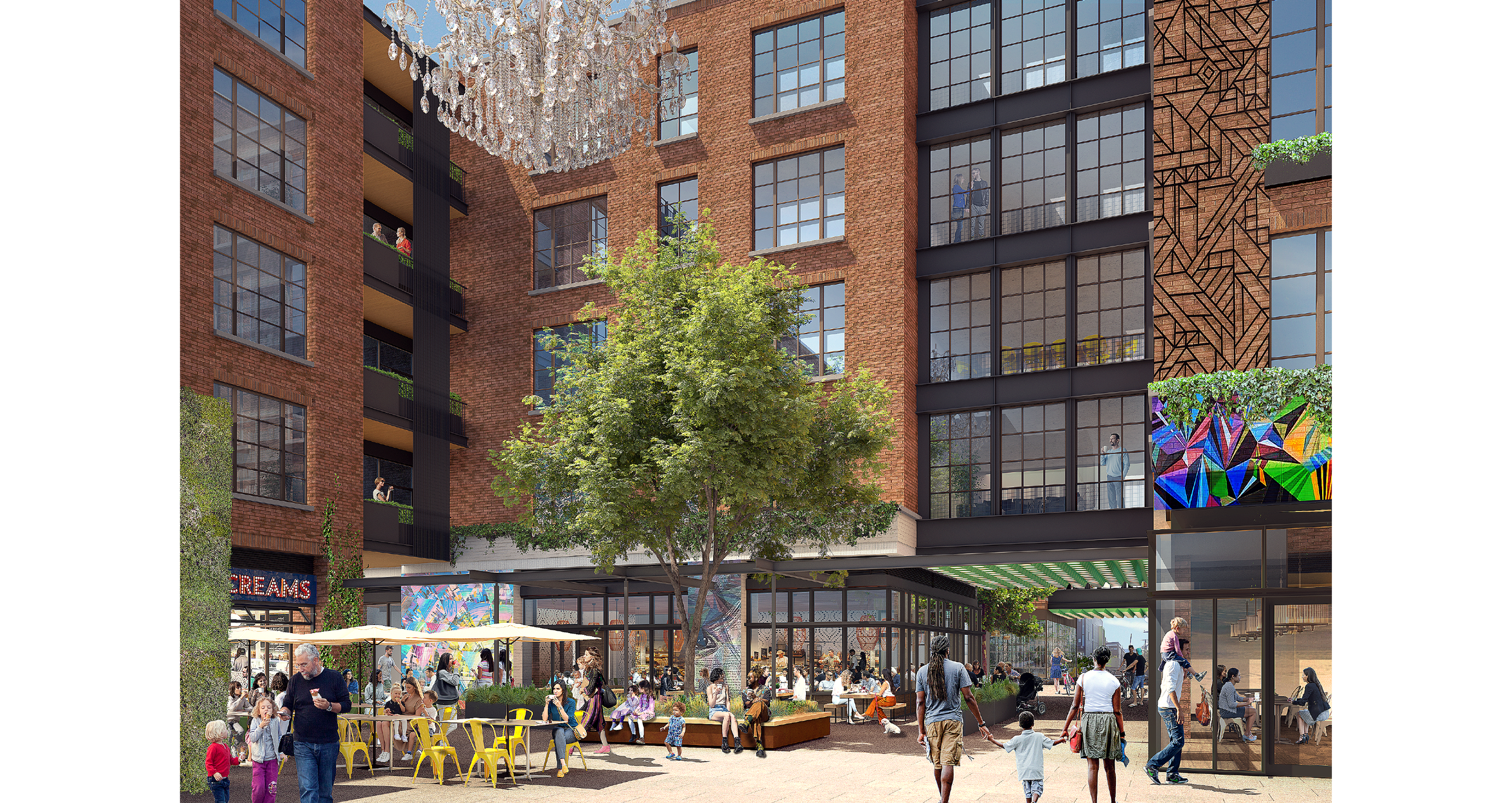 An outdoor courtyard between modern brick residential buildings with large windows, featuring a central green tree, outdoor seating with yellow chairs, families, and people walking. A chandelier hangs from above, and digital artwork displays colorful geometric designs on building facades.