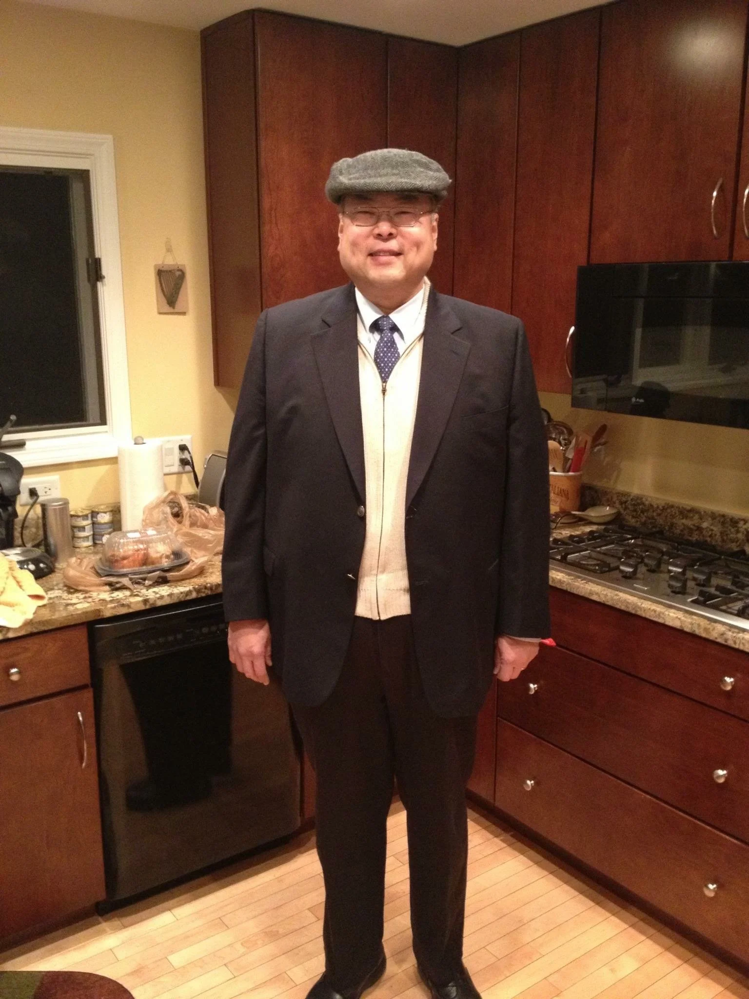 Alice Chen's father dressed in a suit and newsies cap, a portrait reflecting heritage, identity and the inherited stories that inspire The Unlearning Studio