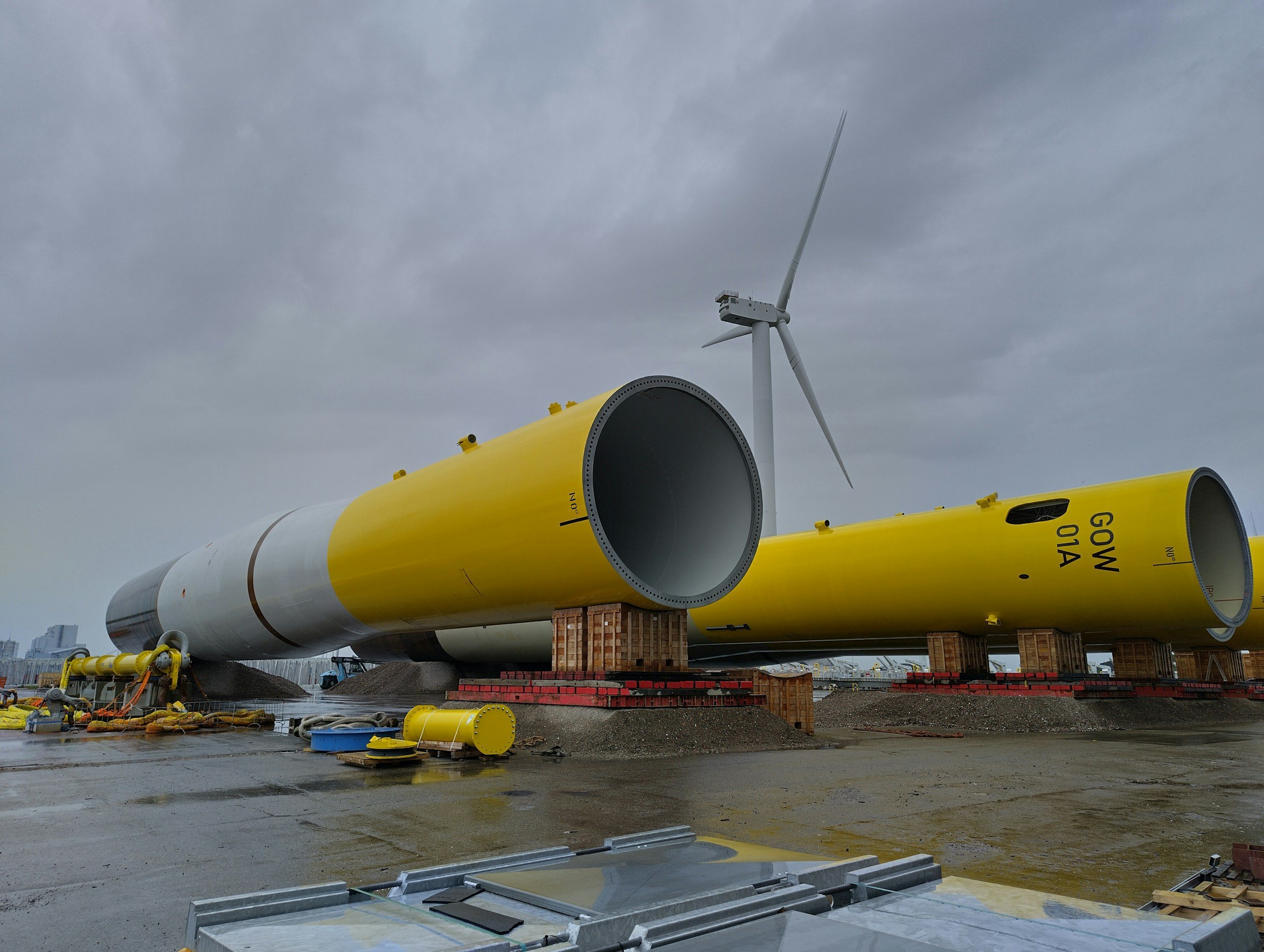 Large wind turbine blades under construction on a construction site with cloudy sky