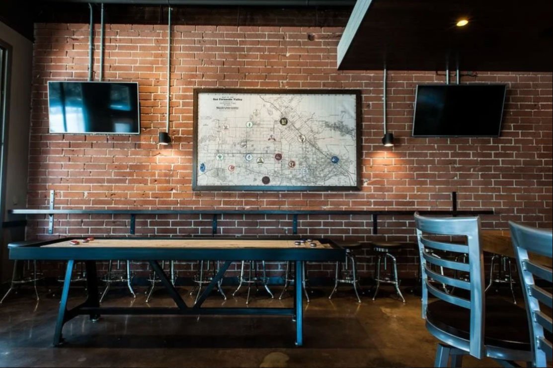 Figure 3: Public School 818, Los Angeles - restaurant interior design integrating graphic art, exposed materials, and digital displays, illustrating how technology and visual storytelling can be embedded into contemporary hospitality design.
