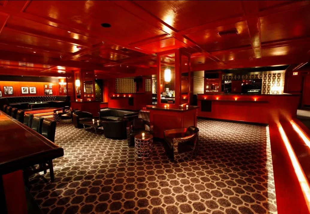 Interior of The Continental Club featuring layered lighting, premium finishes, and comfortable lounge seating.