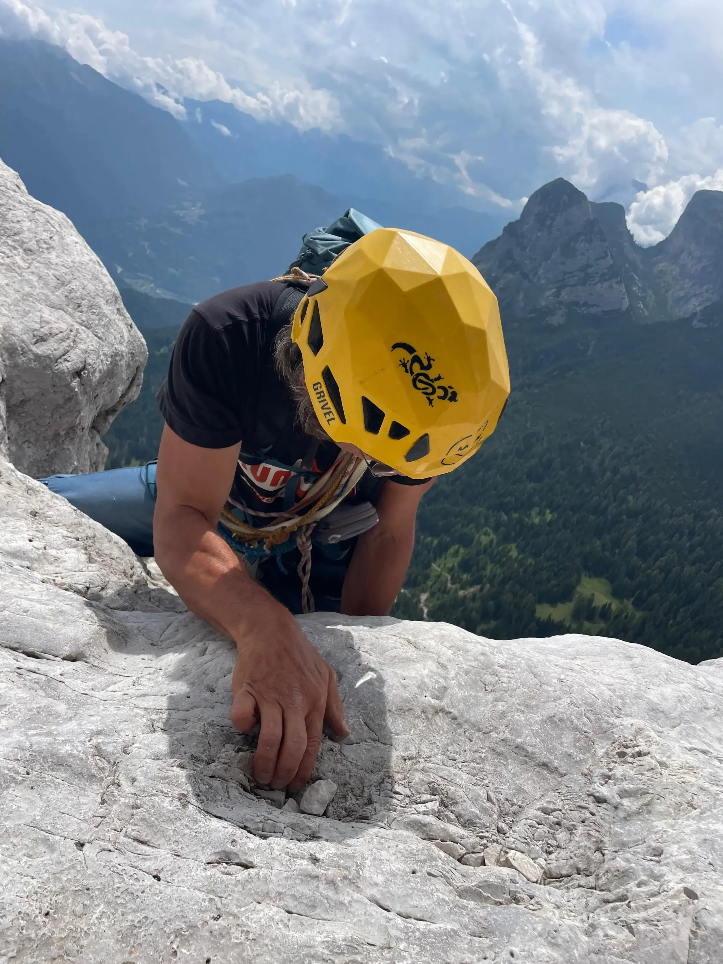 A climber wearing a helmet during outdoor climbing