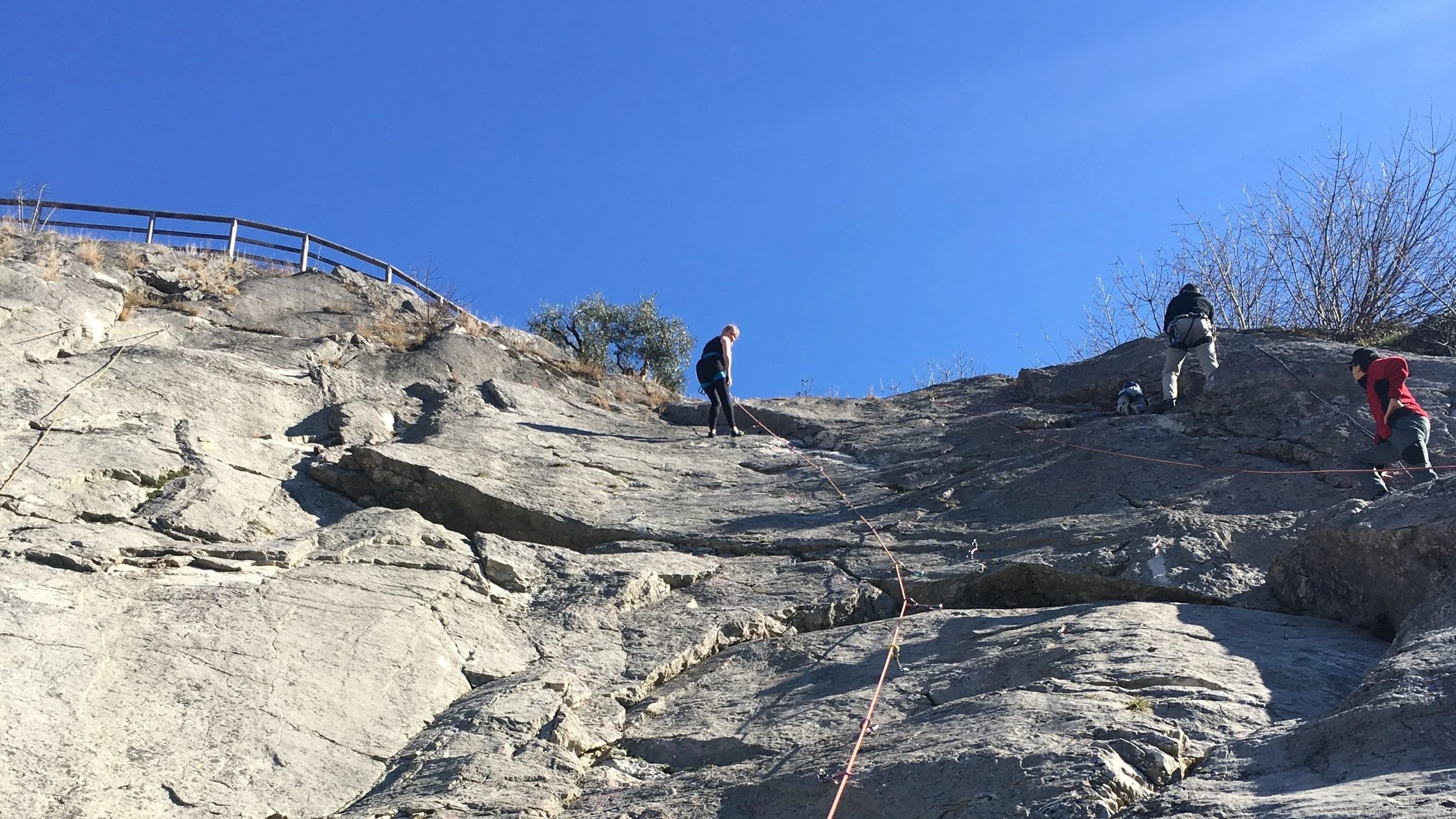 People rock climbing at San Martino crag in Arco, Italy