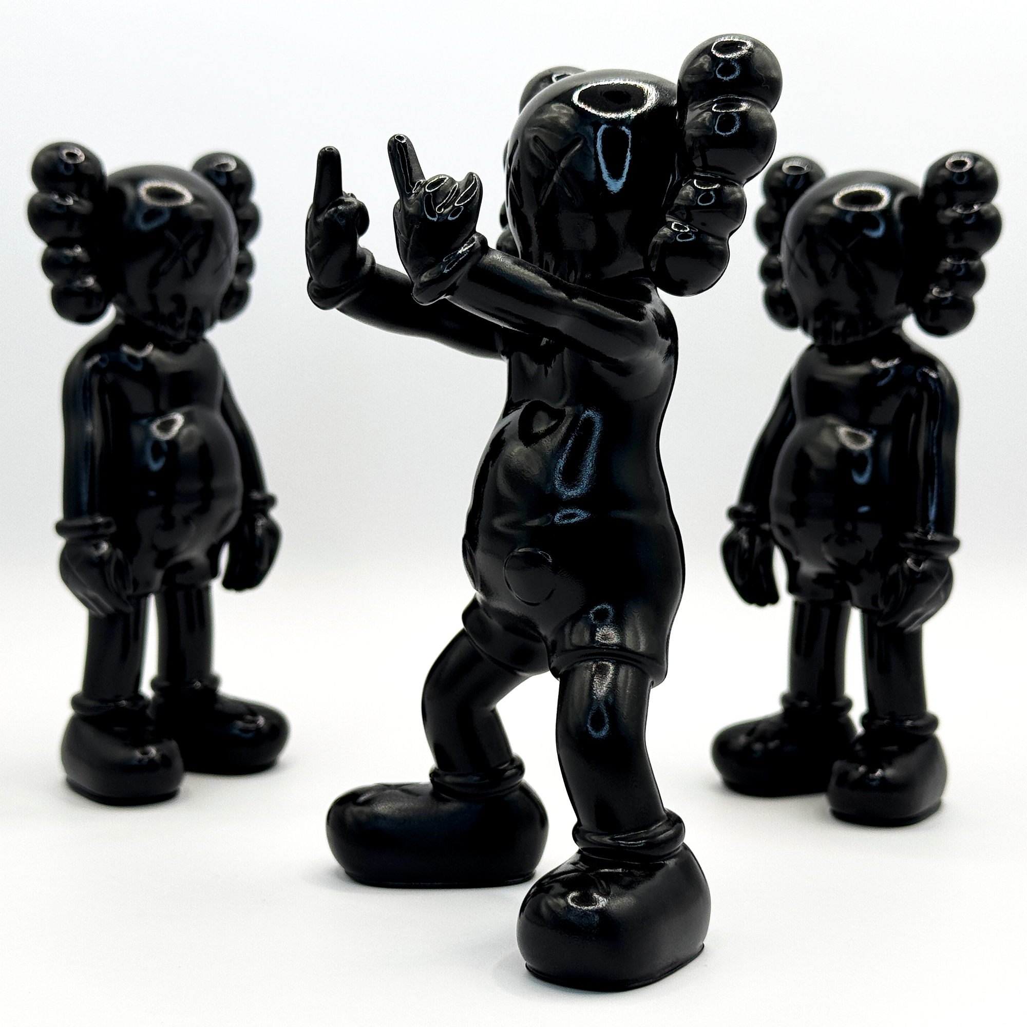 kaws in middle finger pose black figure