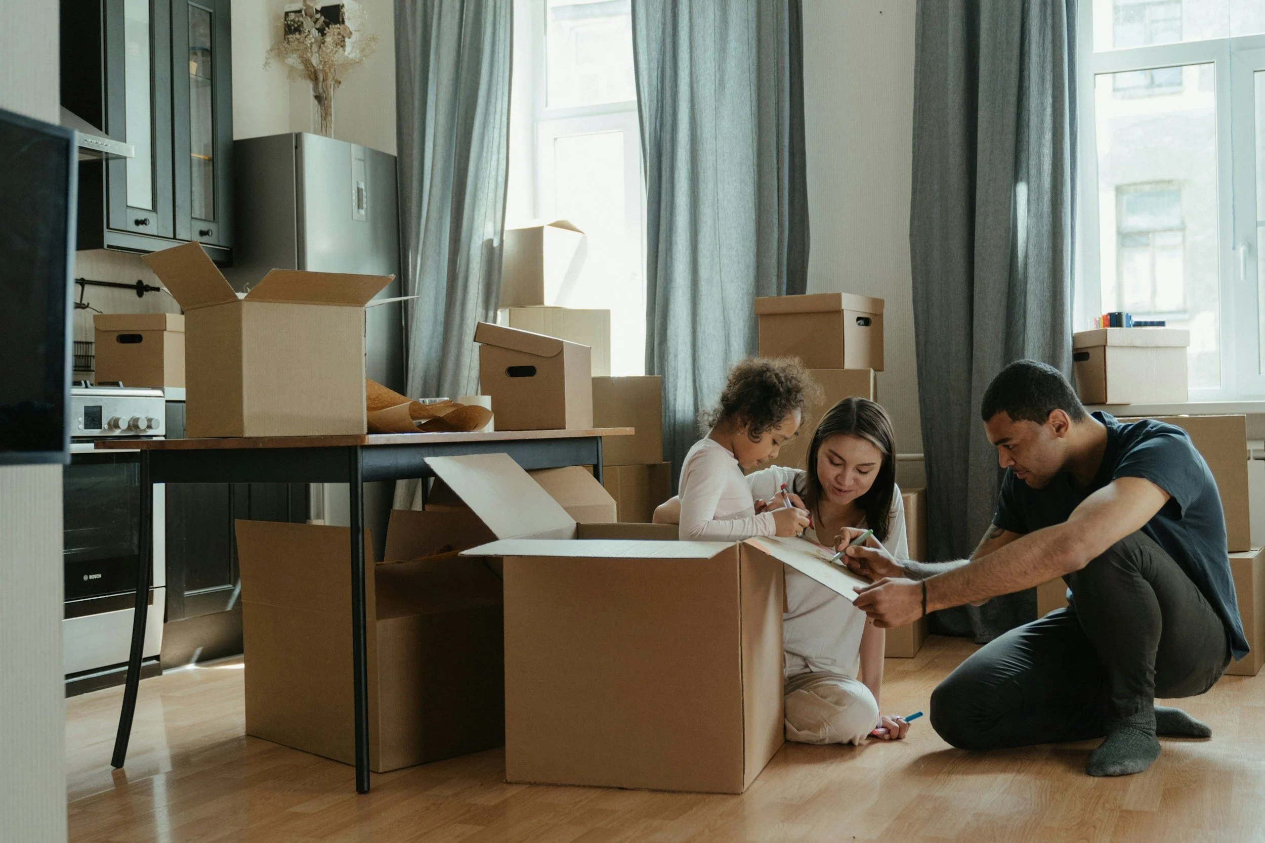 Family moving into their new home with support from a mortgage adviser.