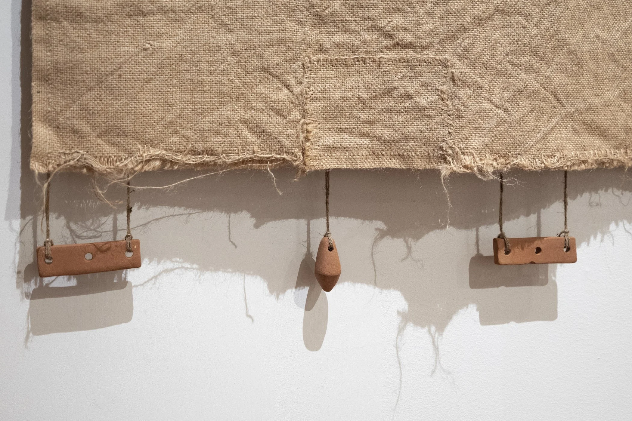 Improvement (production). 2026. (Detail).
Jute hessian fabric, wool, hand-formed papa clay, aluminium tube, jute twine.
120 x 130 cm.
Photo: Shaun Matthews.