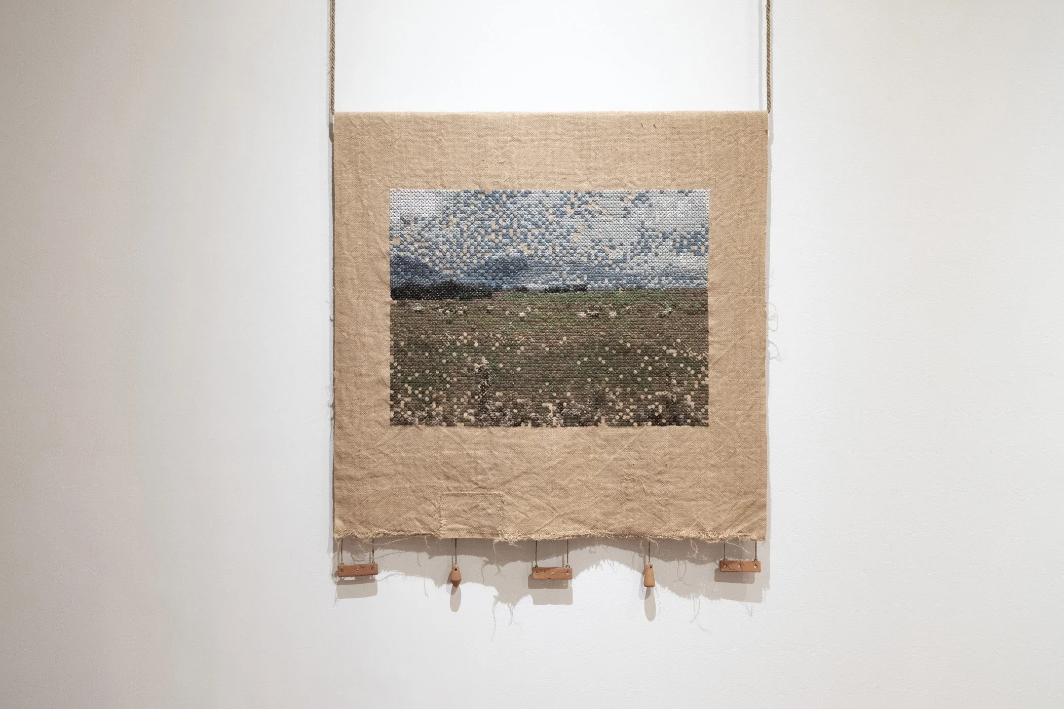 Improvement (production). 2026.
Jute hessian fabric, wool, hand-formed papa clay, aluminium tube, jute twine.
120 x 130 cm.
Photo: Shaun Matthews.