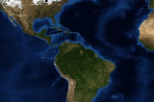 Satellite image of the Americas showing North and South America surrounded by the Atlantic and Pacific Oceans.