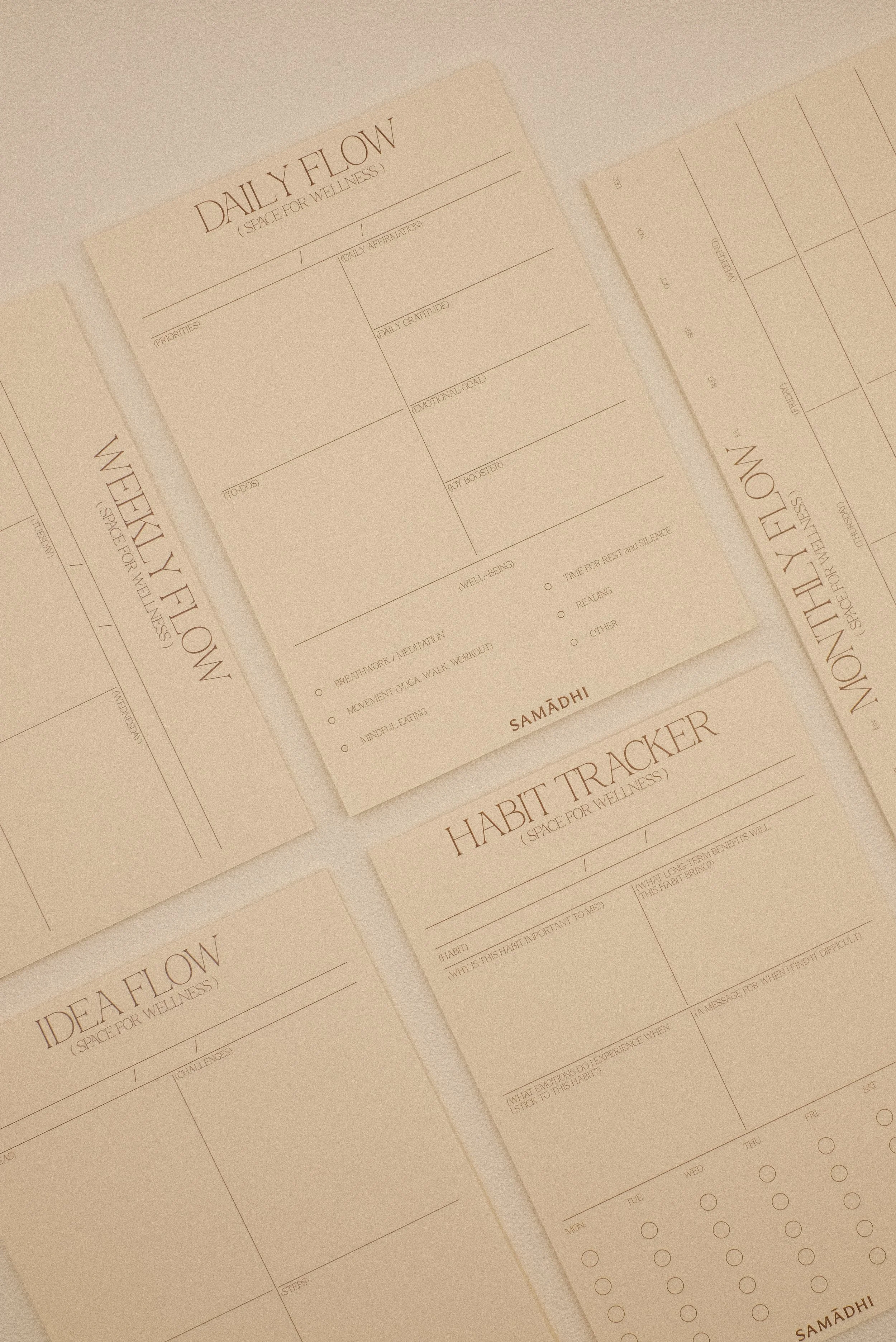 Set of wellness and habit tracking pad sheets with sections for daily flow, weekly flow, idea flow, and habit tracker, all in a minimalist design. Daily, weekly and monthly planners with a focus on well-being.