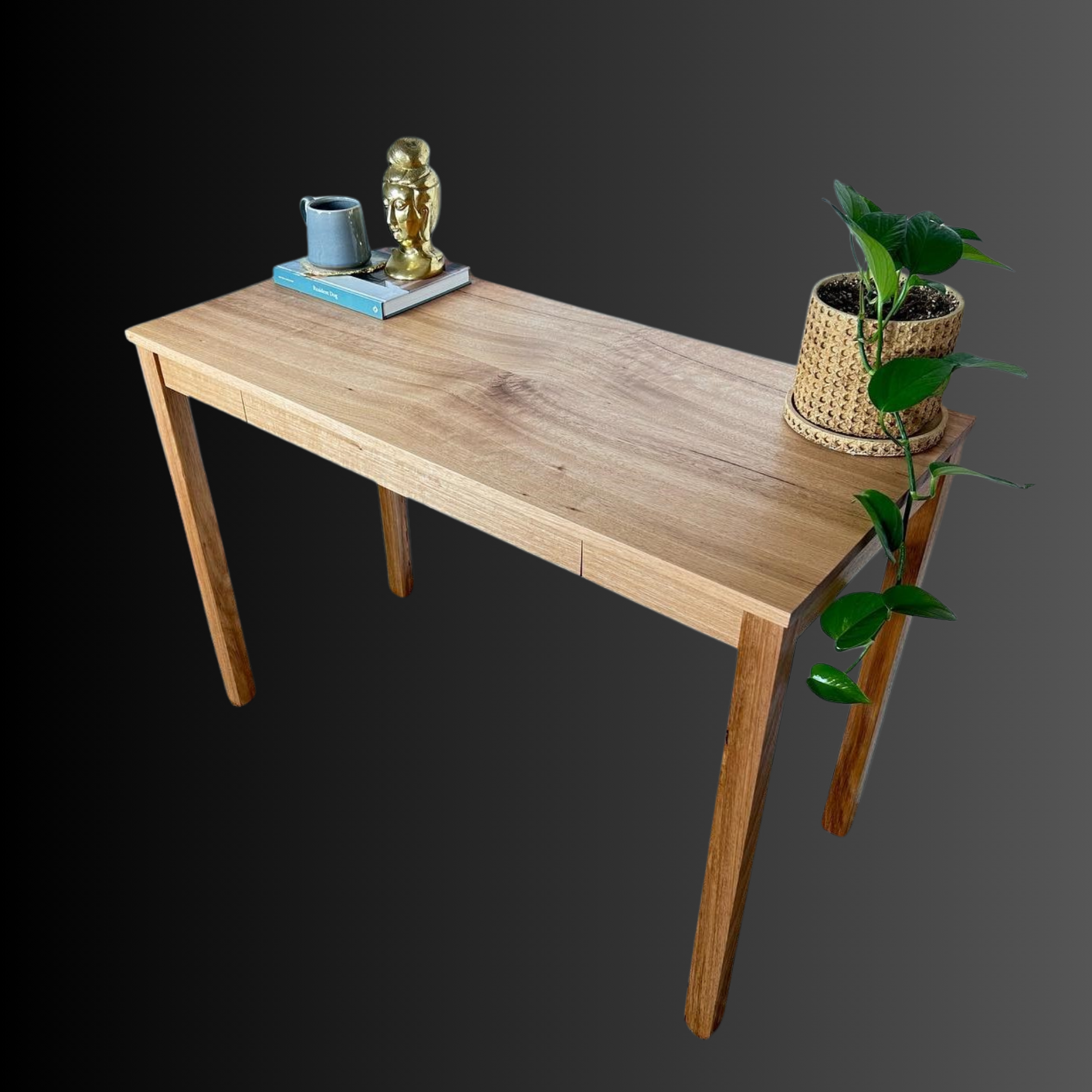 Wooden console table with a potted plant and decorative items on top, set against a gradient dark background.