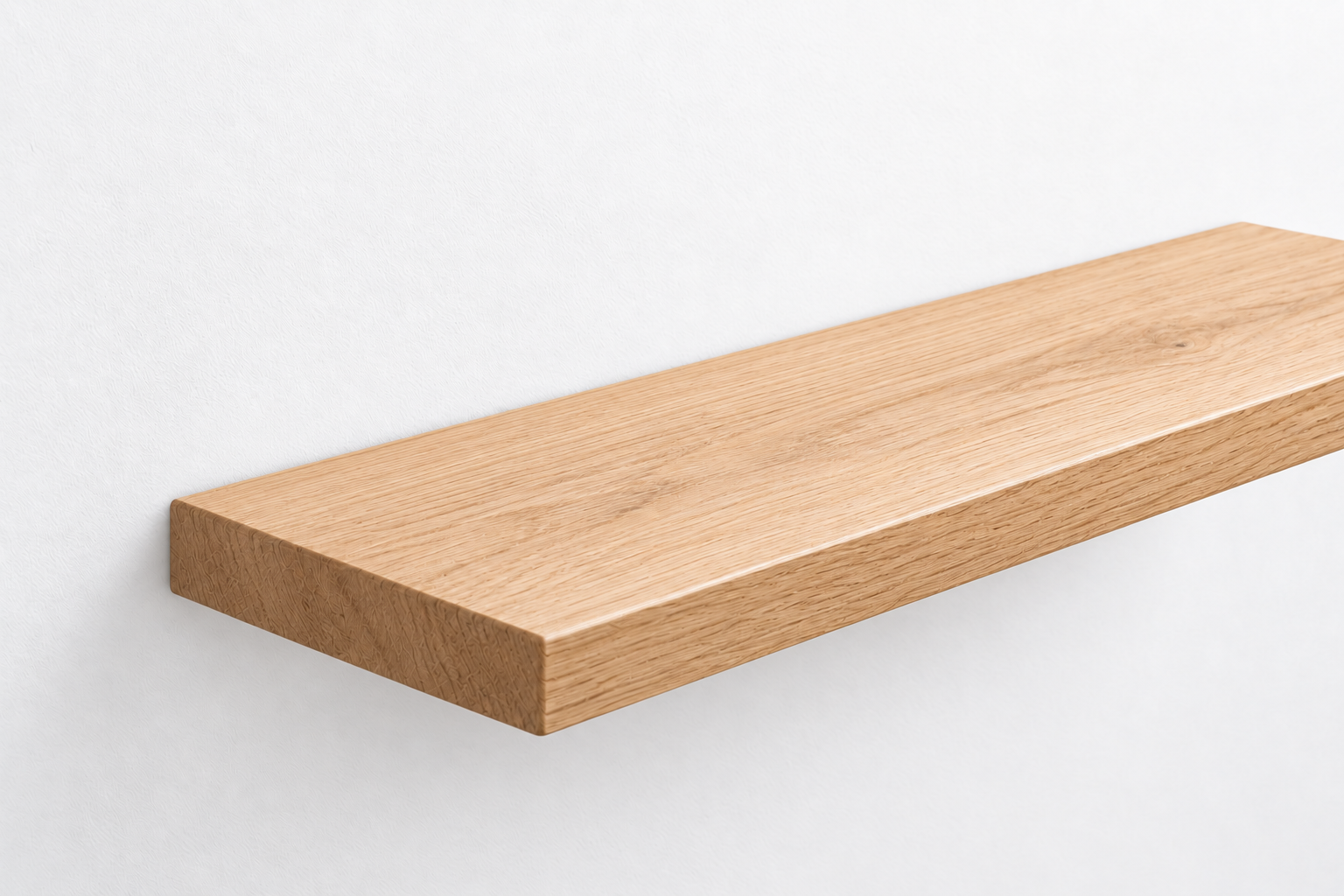 American Oak floating shelf mounted flush against a white wall with concealed fixings.