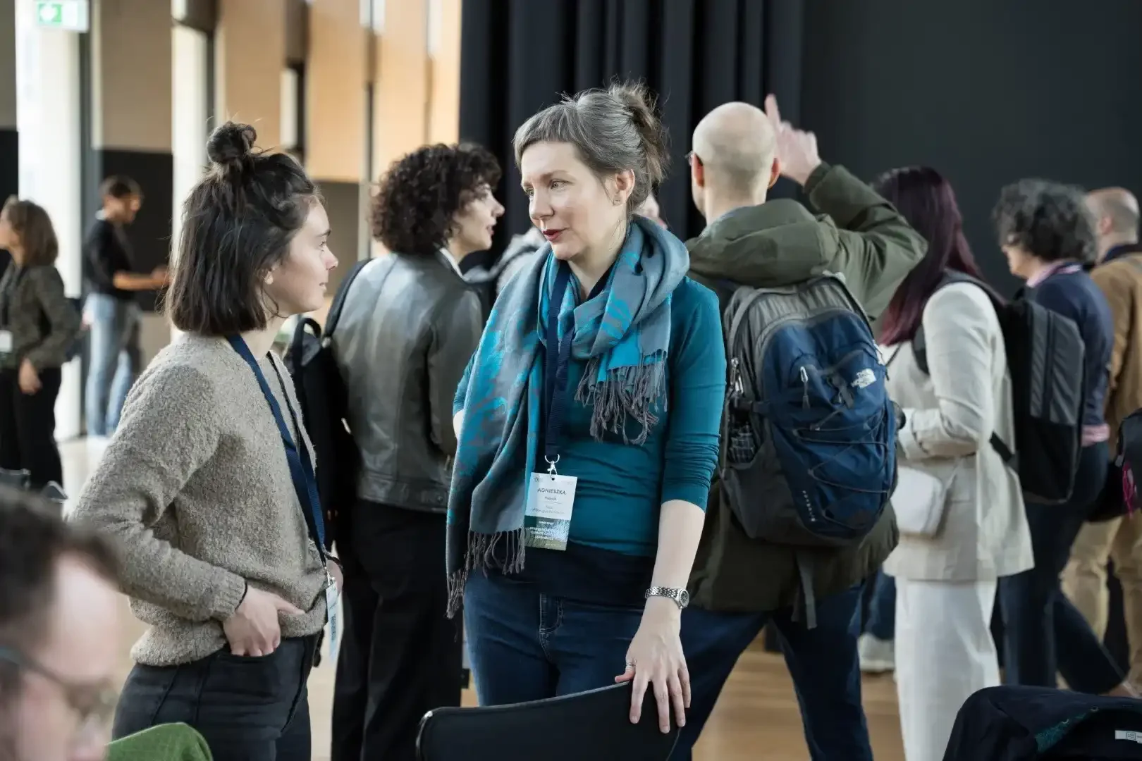 Image showing Agnieszka Pedzic Talking to another woman at the Spring School 2023. The quote on the right of the image belongs to her.