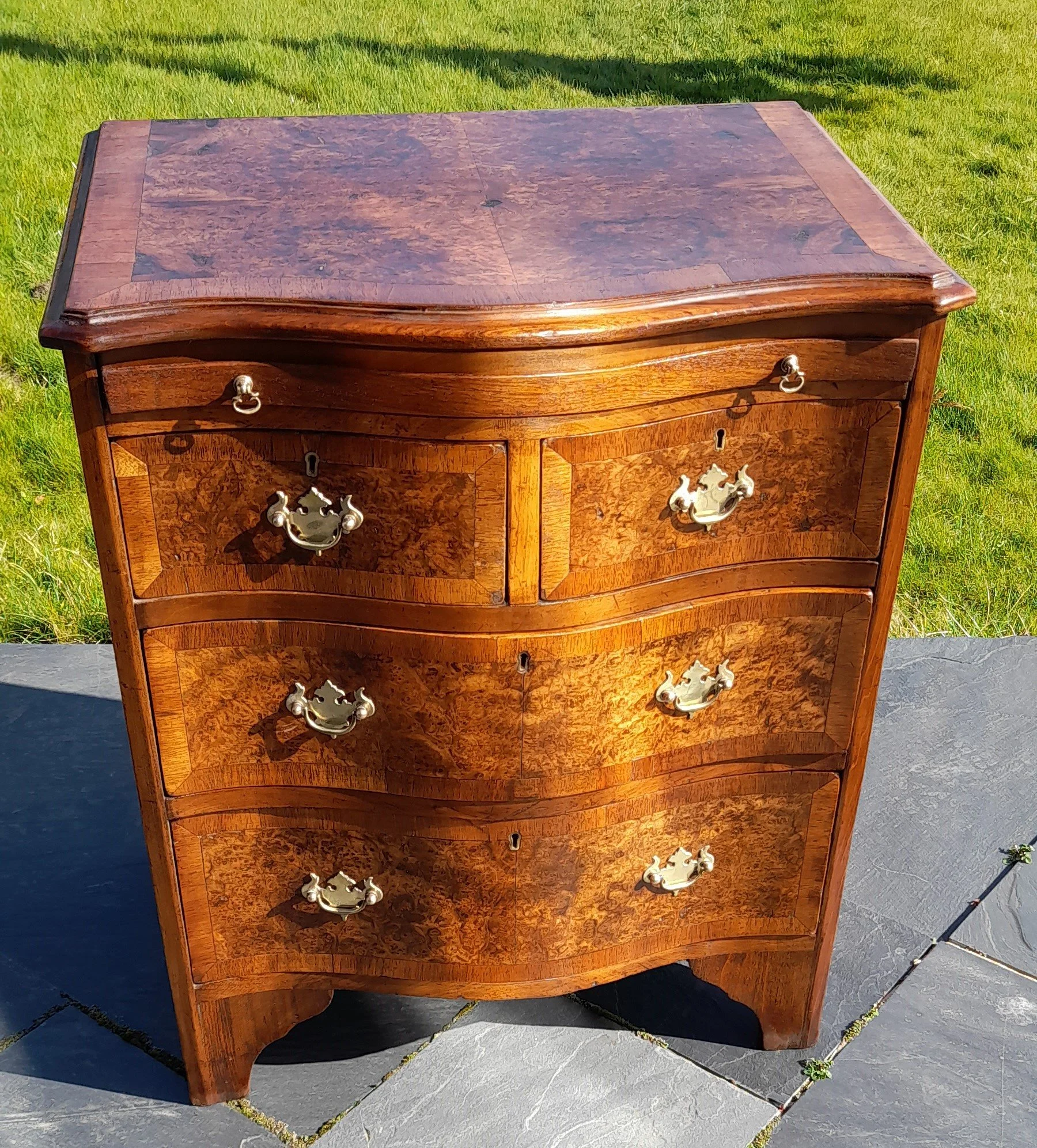 C1920s small Gentlemans walnut 4 drawered chest with brass handles and a brushing slide above drawers