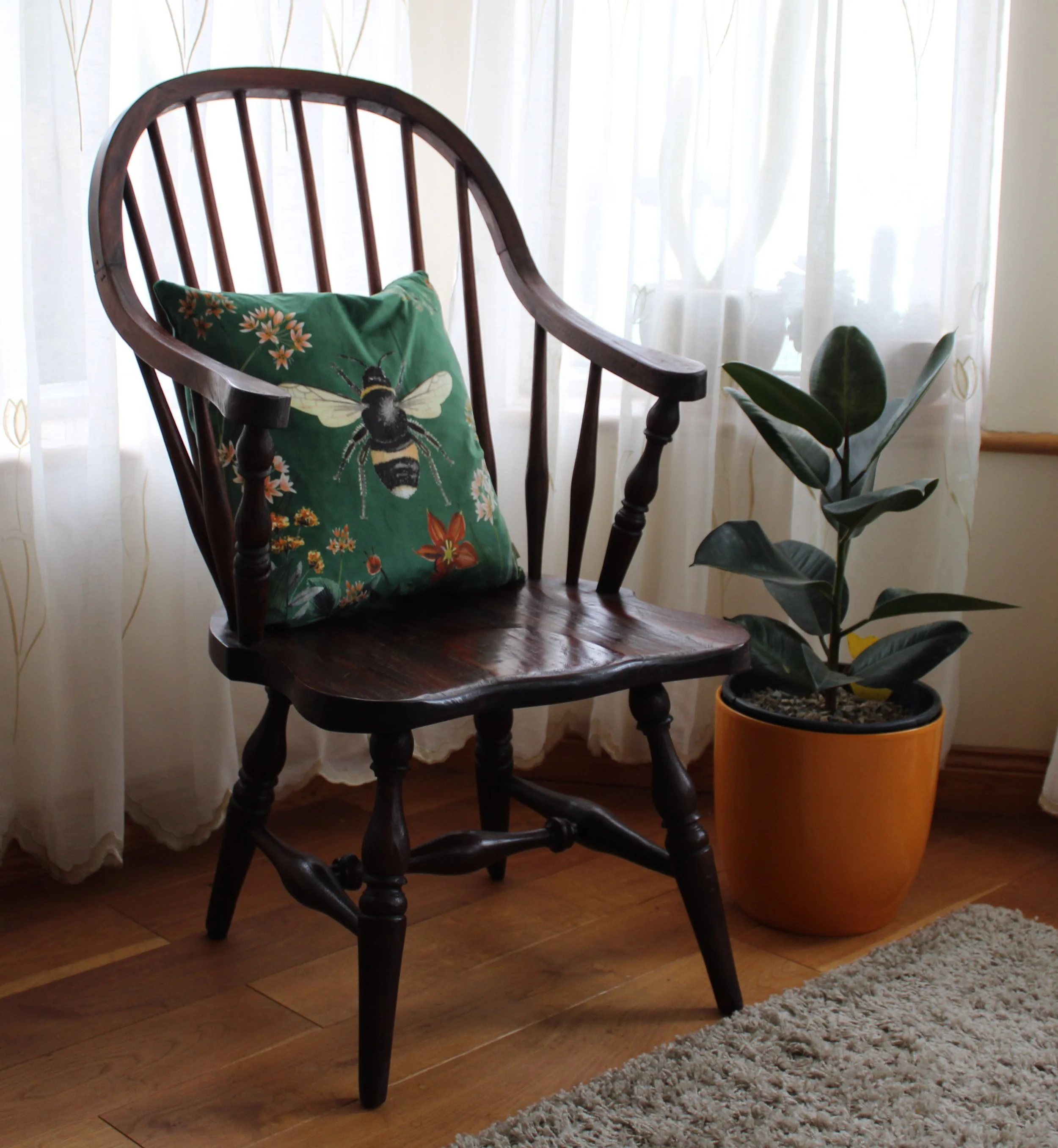 oak windsor style chair with cushion being shown for Image