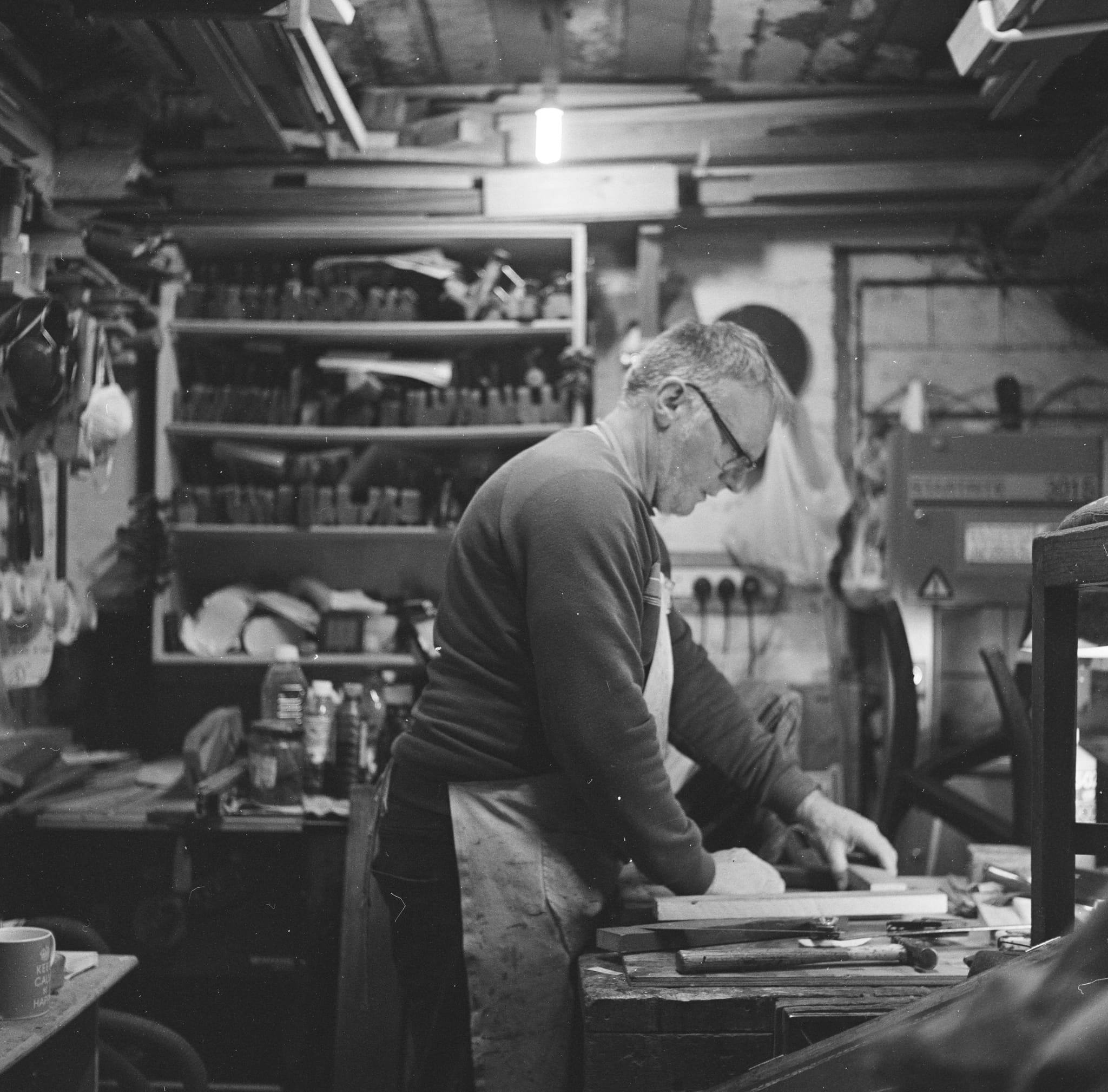 Black and white photo of a workshop of Malcolm Rumley Antiques