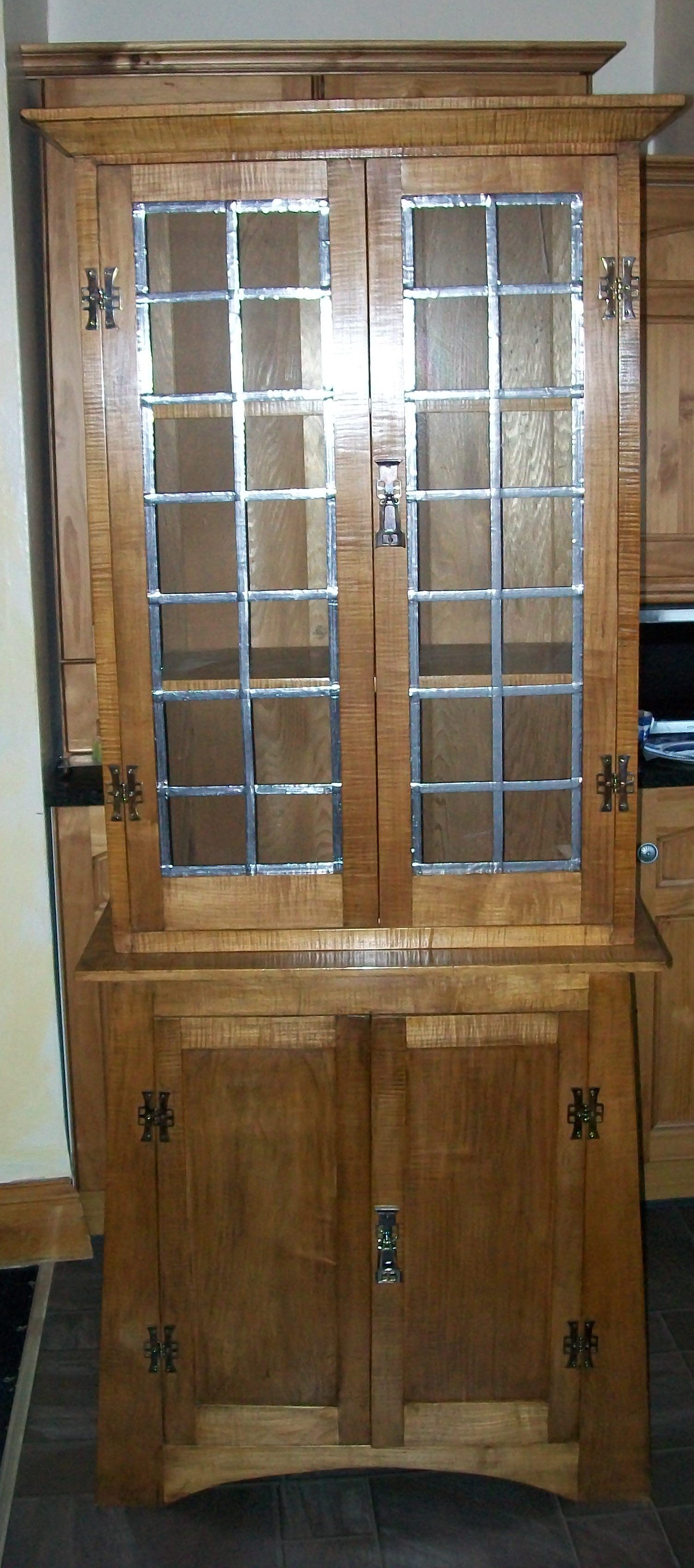 Reproduction Arts and Crafts style  Cabinet with glazed leaded doors to the top and blind doors to the base, all finished with a Sycamore Veneer