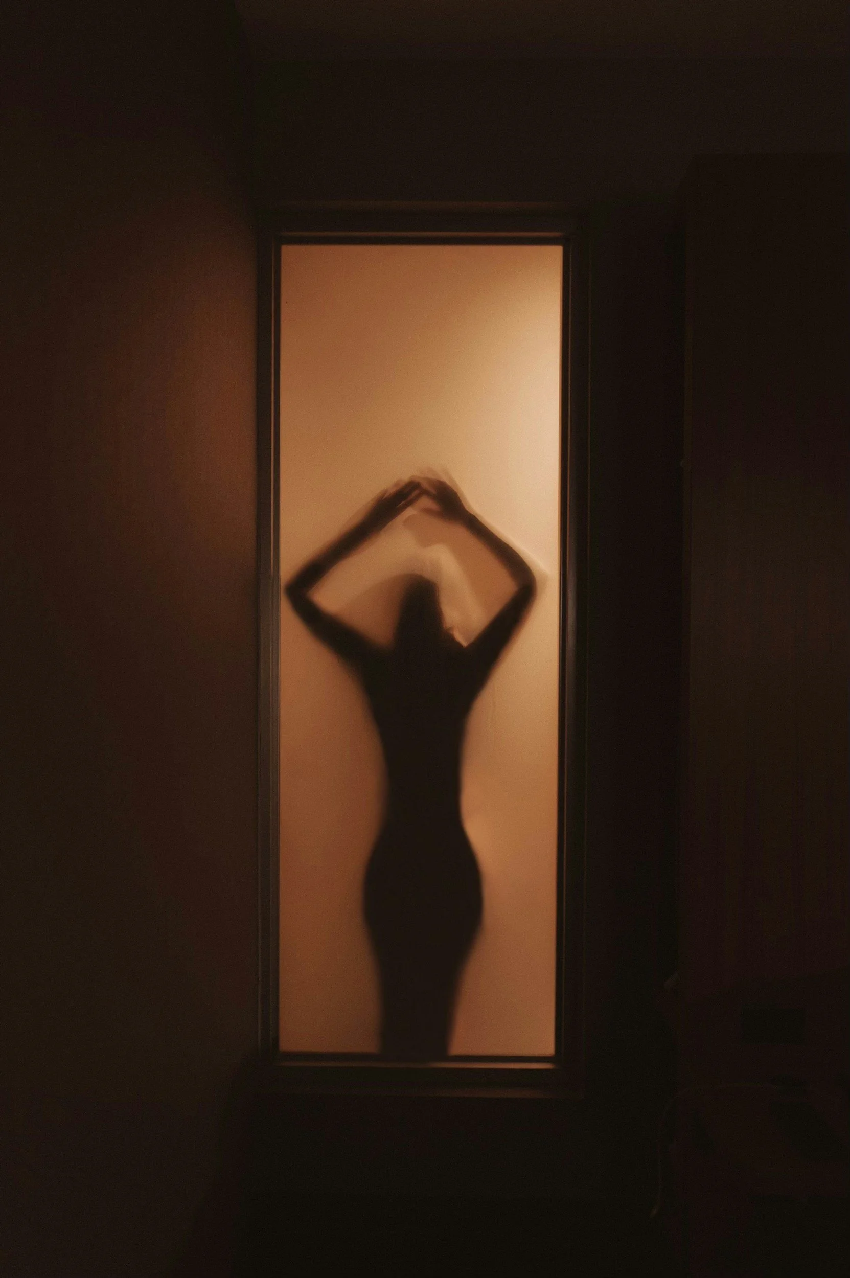 Woman silhouette in doorway—threshold crossing