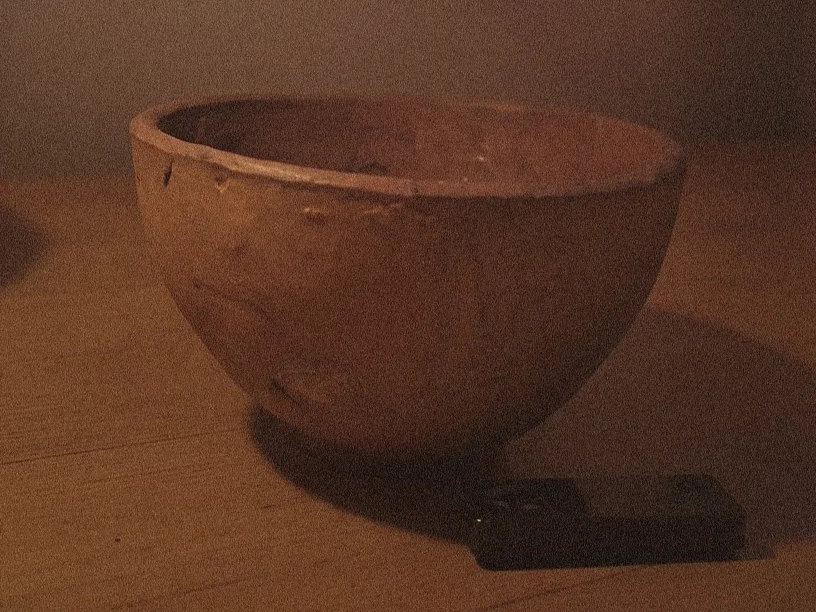 Earthen bowl releasing smoke in low light, symbolizing ritual pause, containment, and the quiet aftermath of transformation.