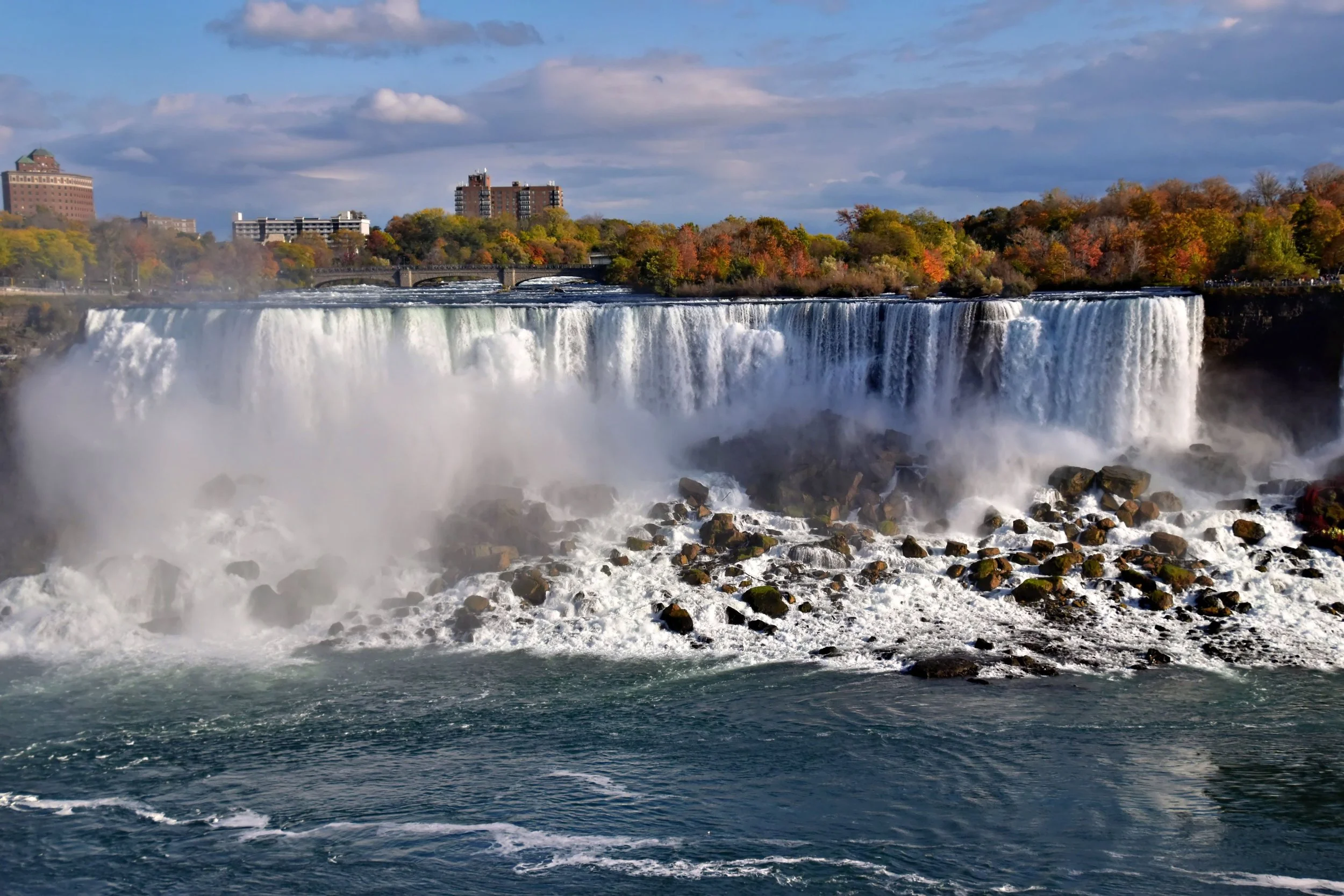 American Falls at Niagara Falls surrounded by colorful autumn foliage.
