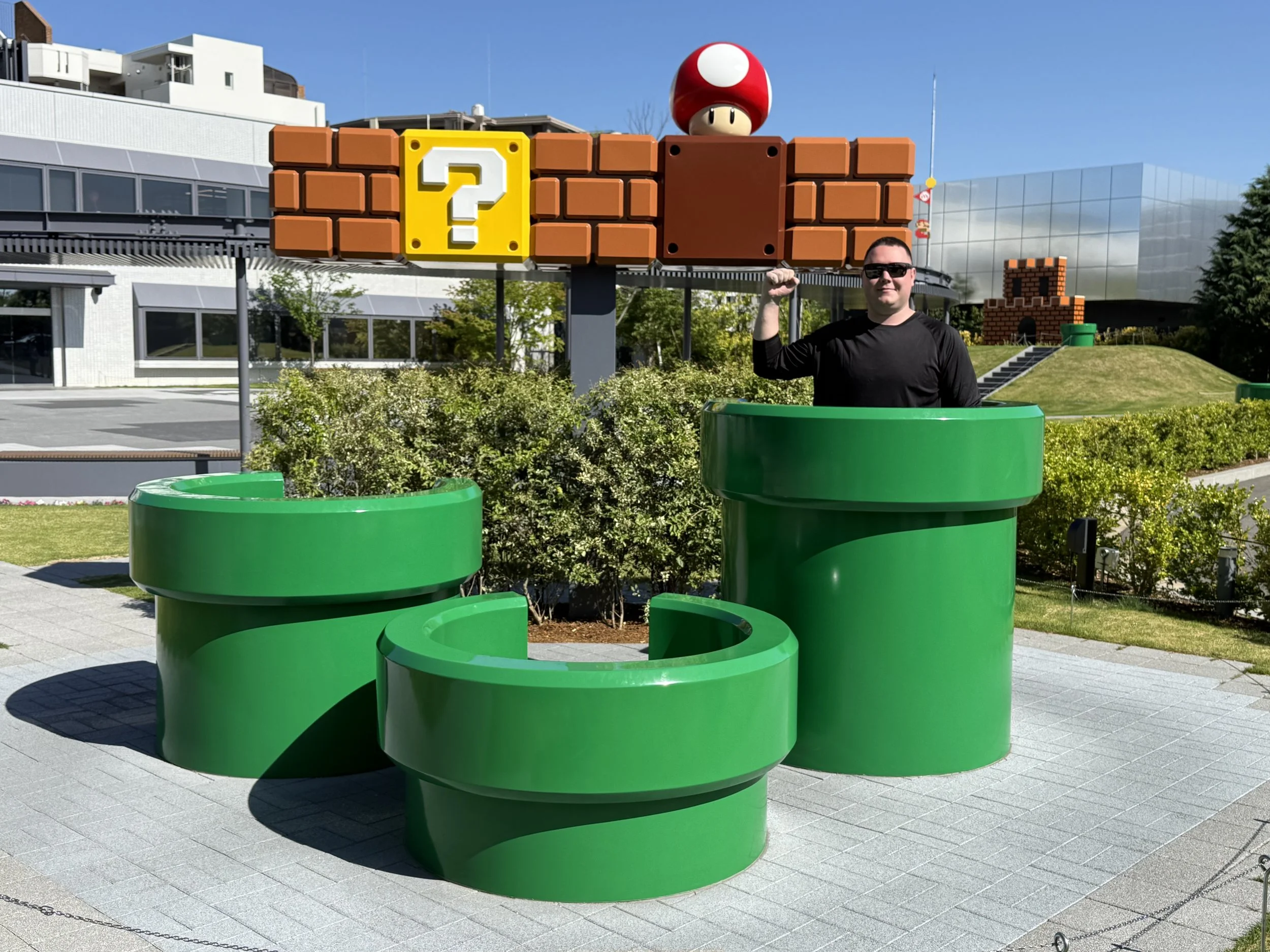 The founder of Glucose Getaways standing in a Green Tube reenacting the Mario Brothers pose at the Nintendo museum in Japan on the 40th anniversary year. 