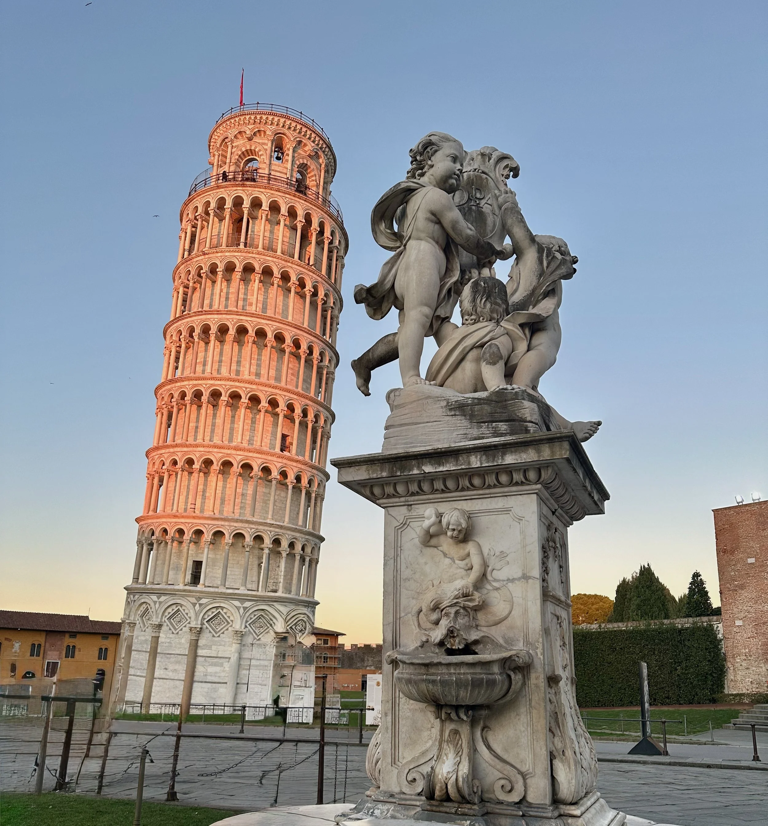 The iconic Leaning Tower of Pisa under a blue sky in Pisa, Italy.