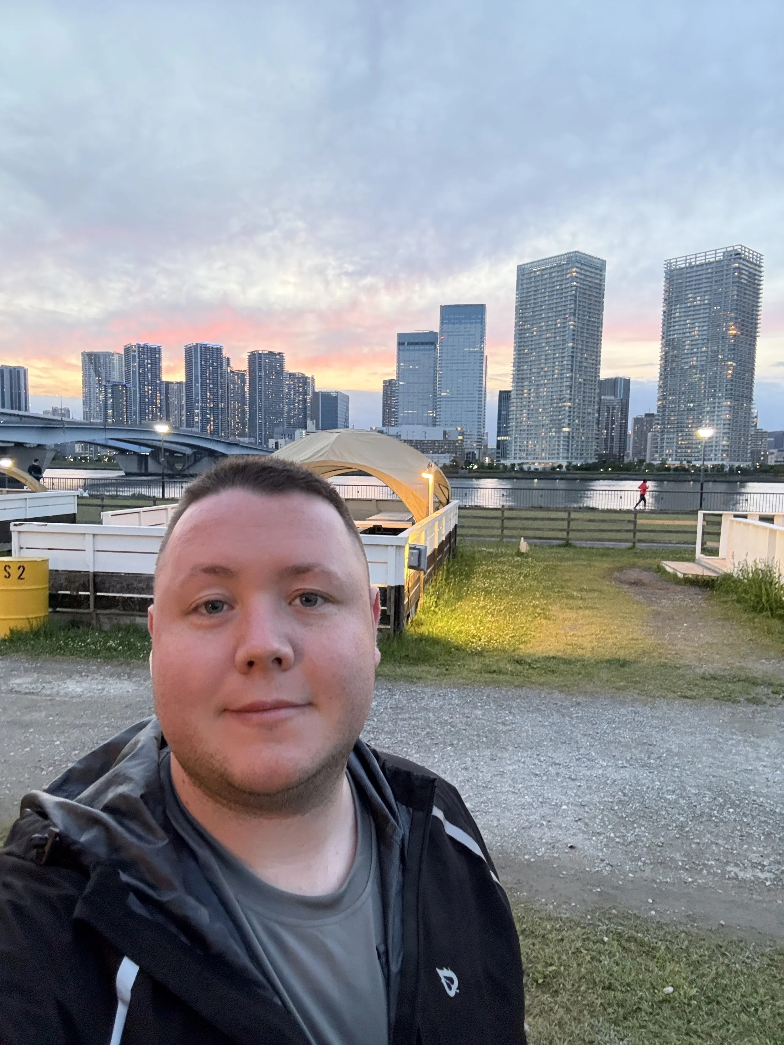The founder of Glucose Getaways standing in front of the skyline of Tokyo City Japan.