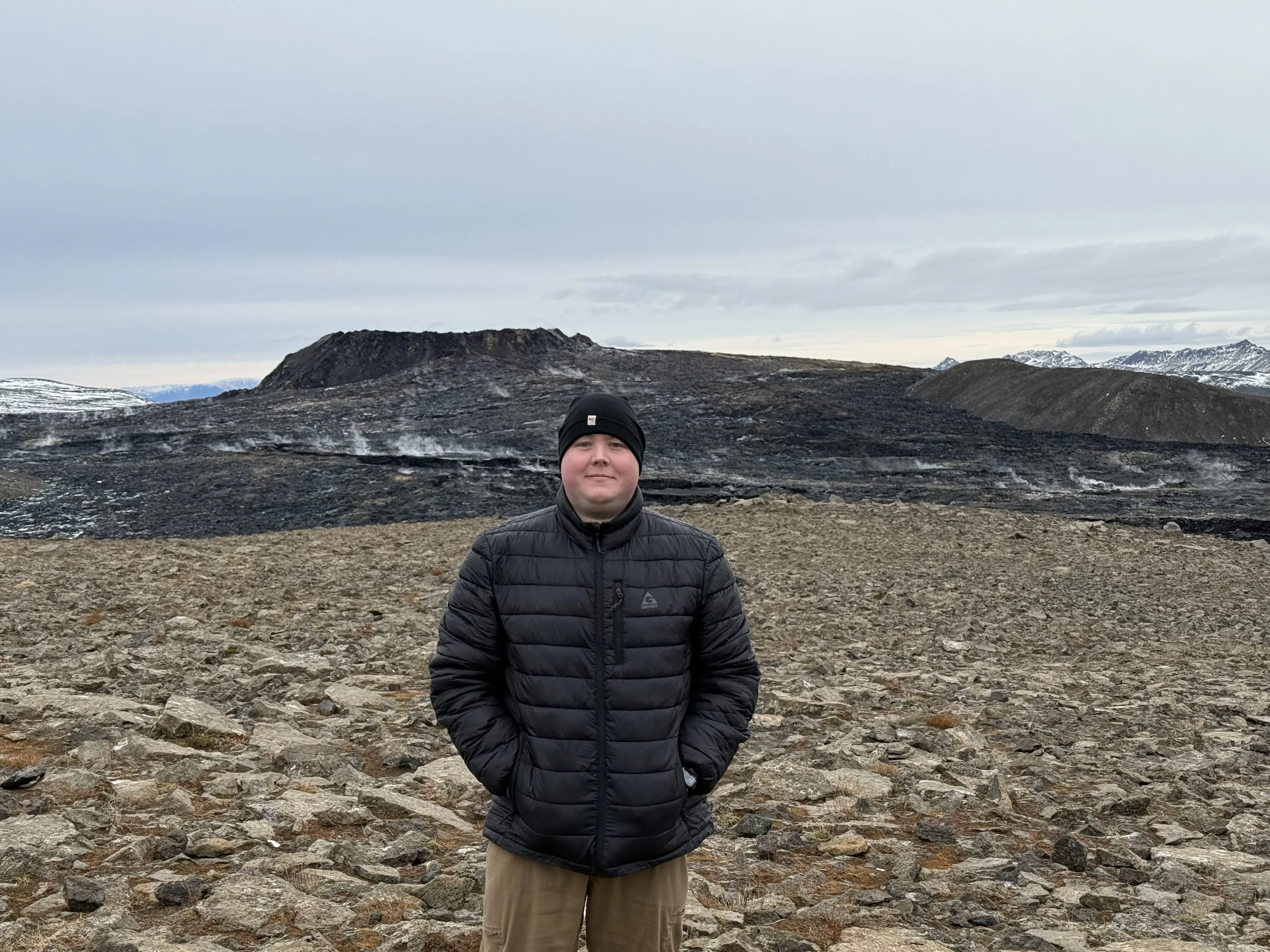 The founder of Glucose Getaways standing at the top of the volcano in Iceland just a couple months after it erupted. 