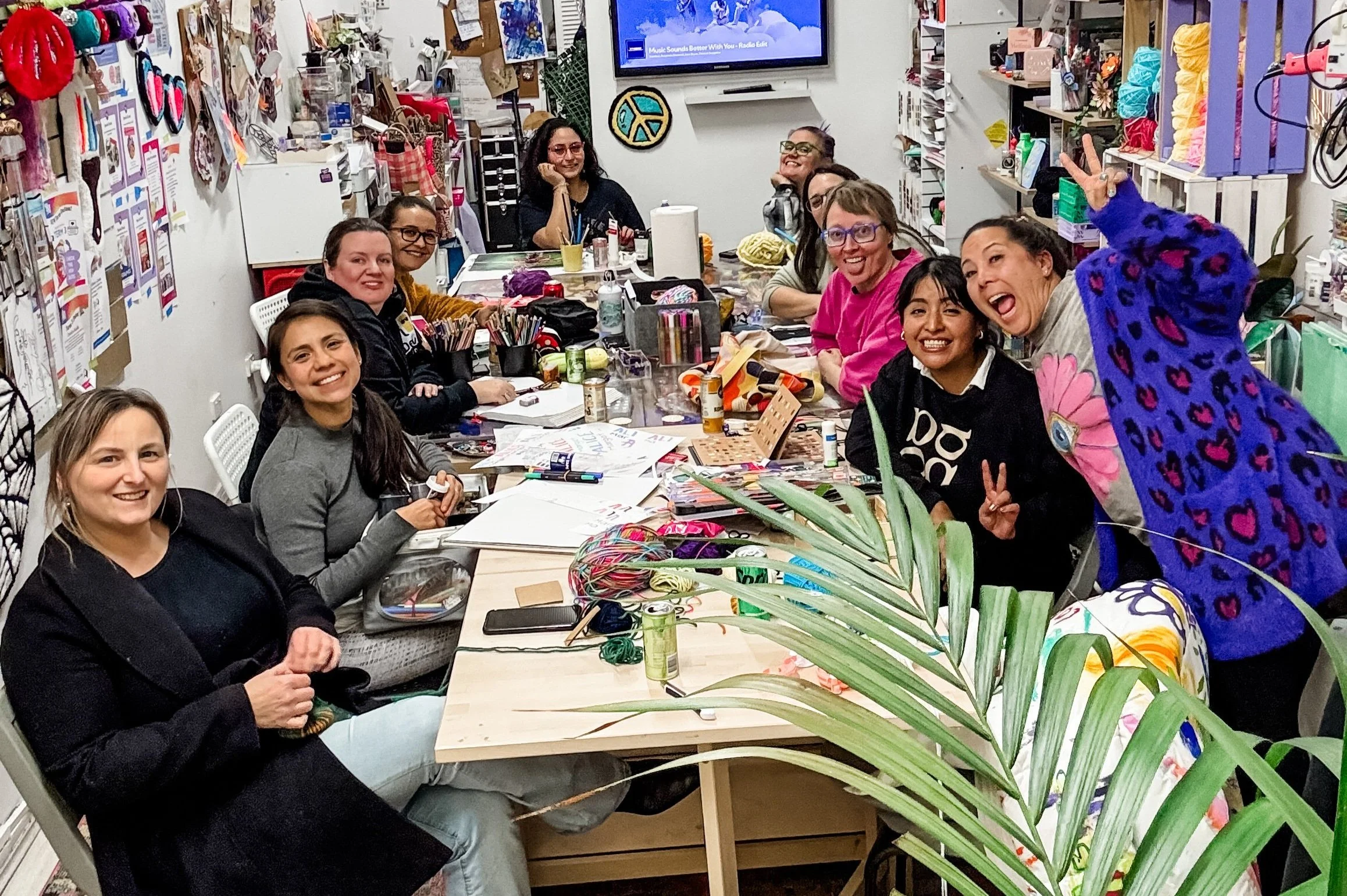 Creative community around the table at the makerspace with crafts