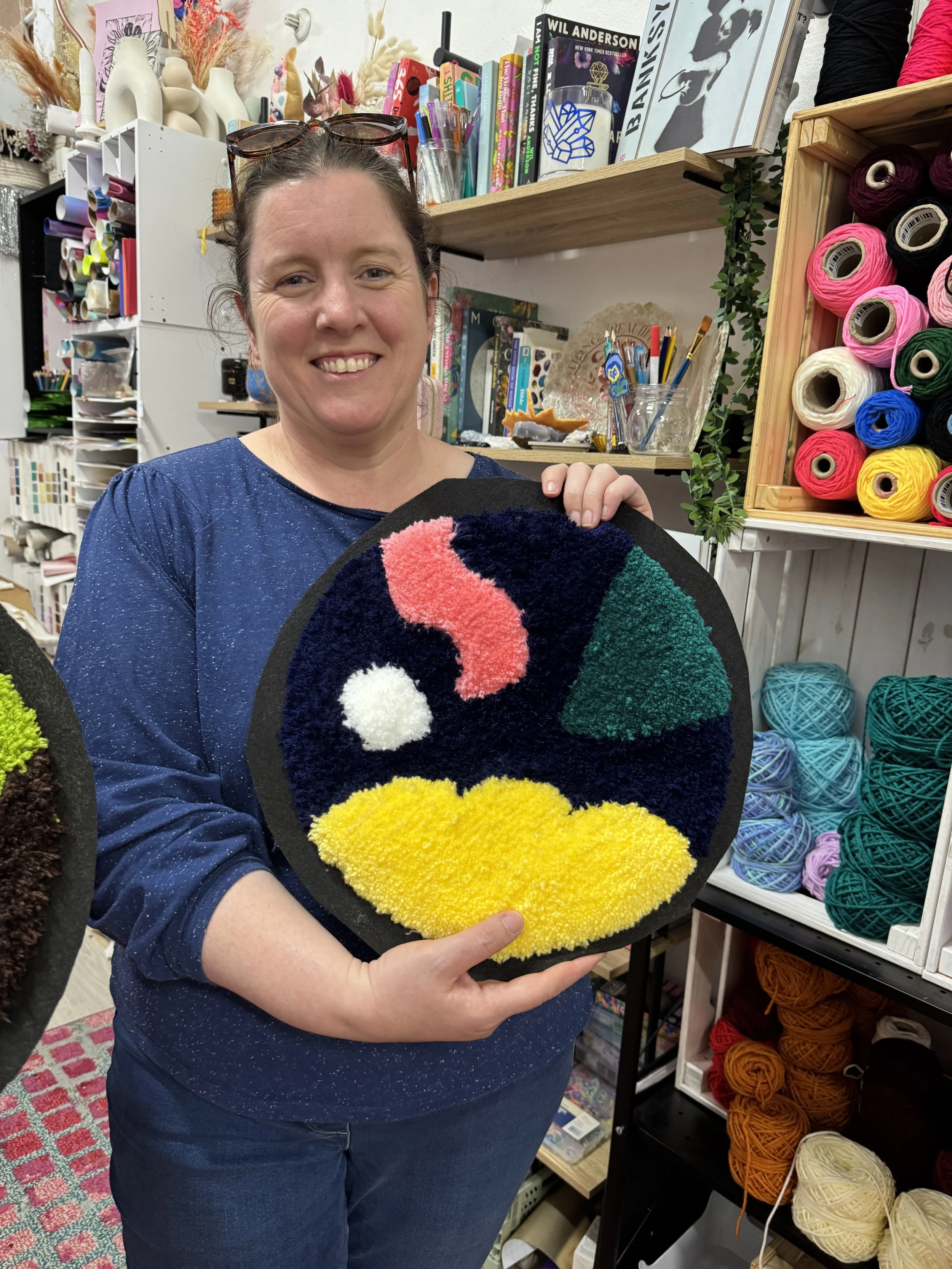 woman holding her abstract art piece