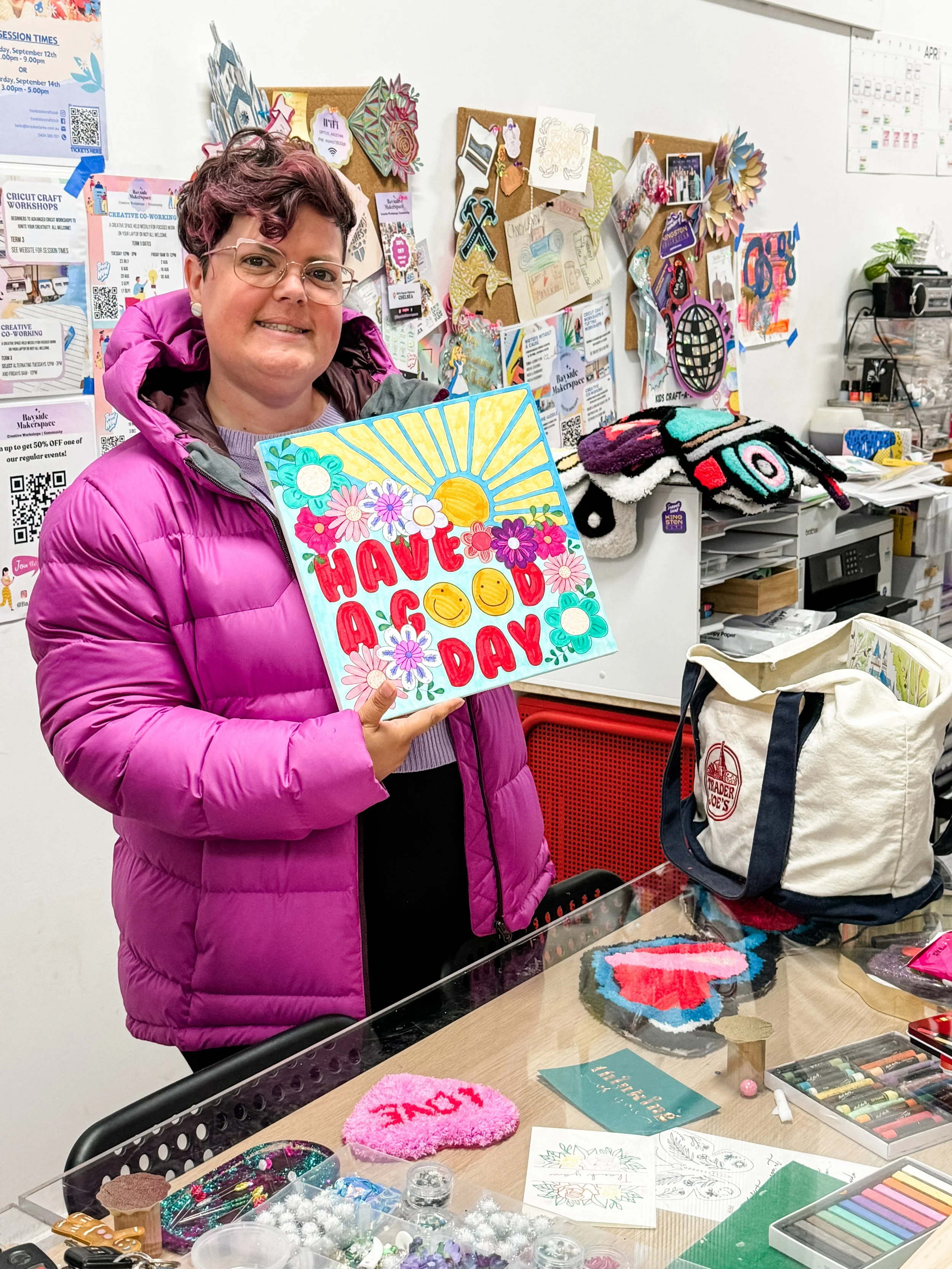Artist community member holding up an alcohol ink canvas art