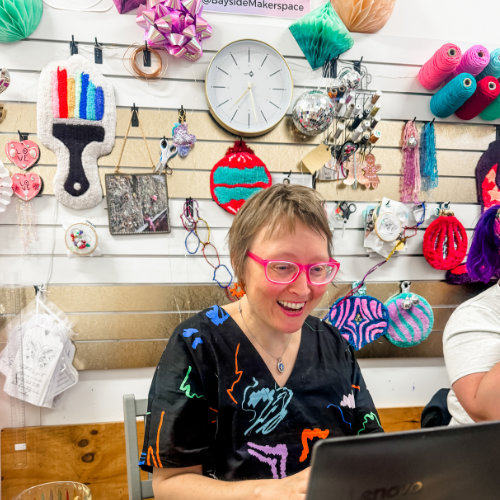 Woman on lap top working happily