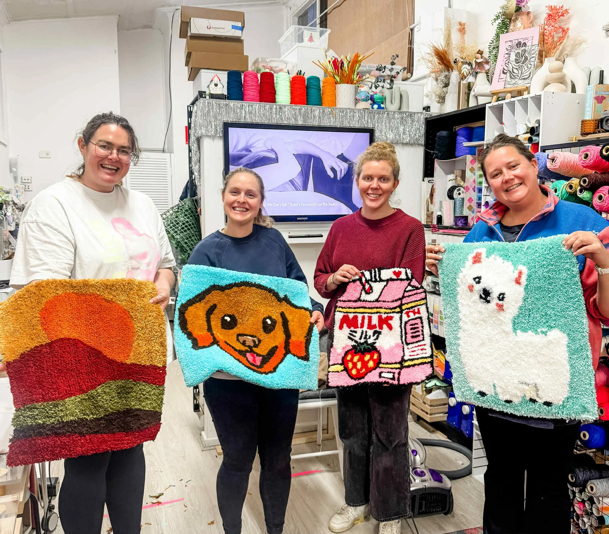 four friends creating tufted rugs together