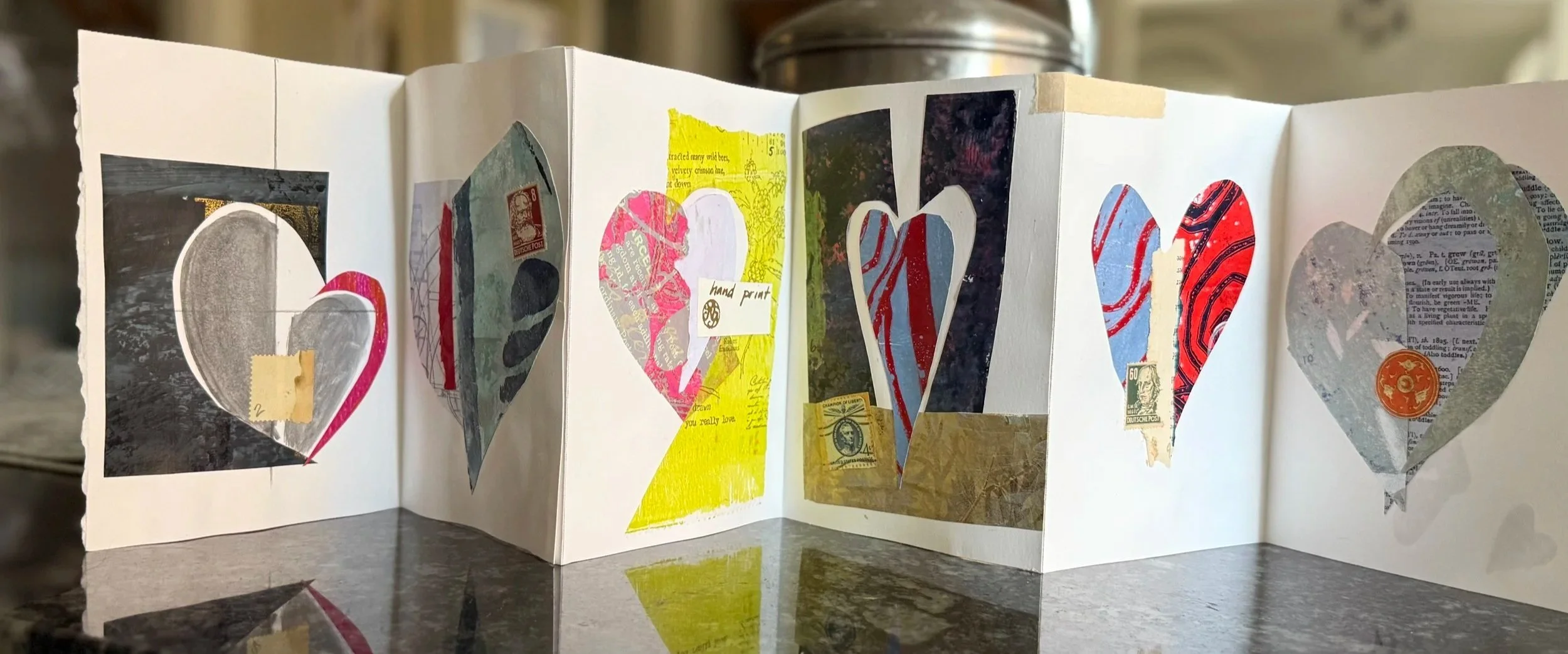 a handmade accordian fold art book of collage pieces