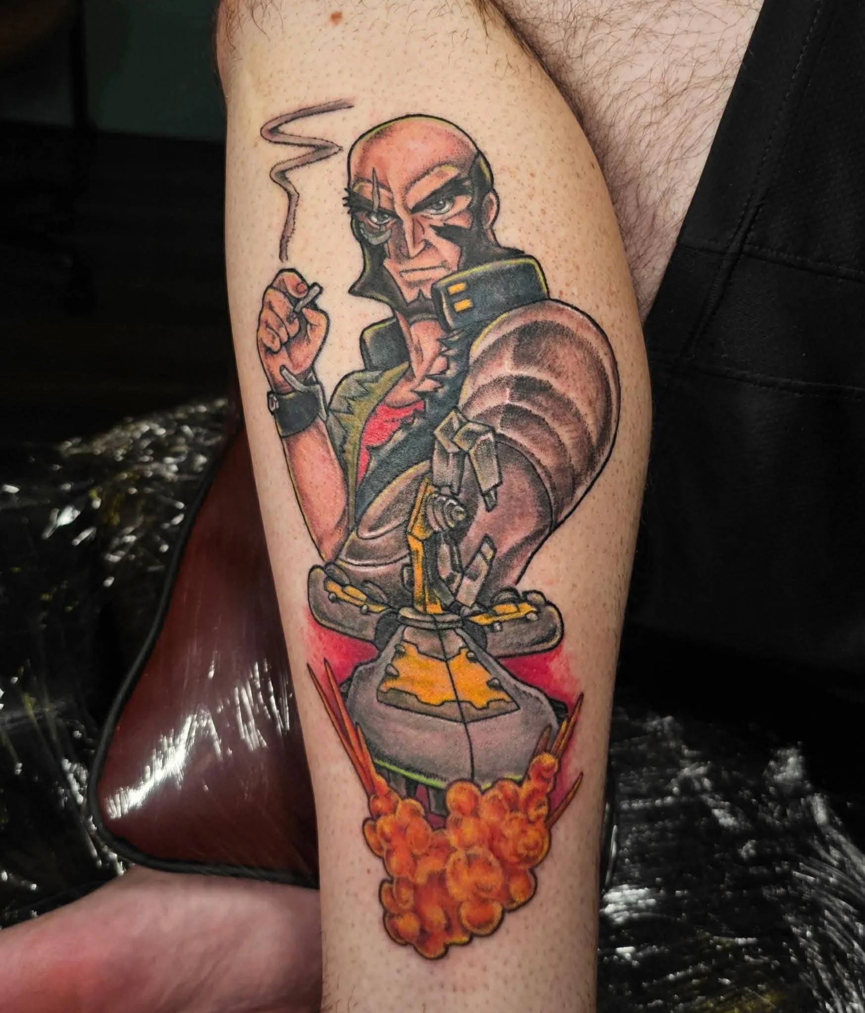 A tattoo of Jet, a character from Cowboy Bebop, and his ship, Hammer Head. 
