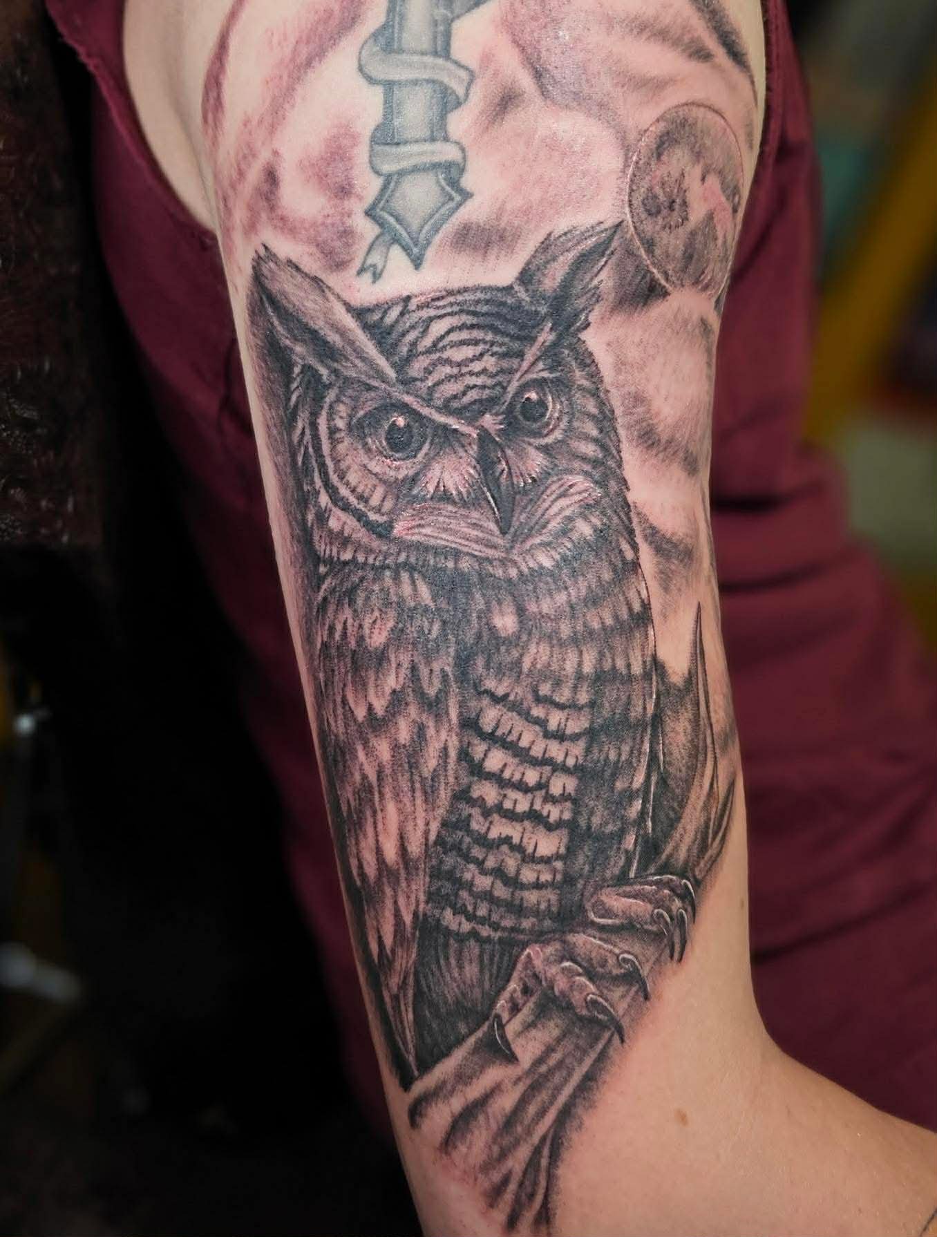 A greyscale tattoo of an eastern screech owl.