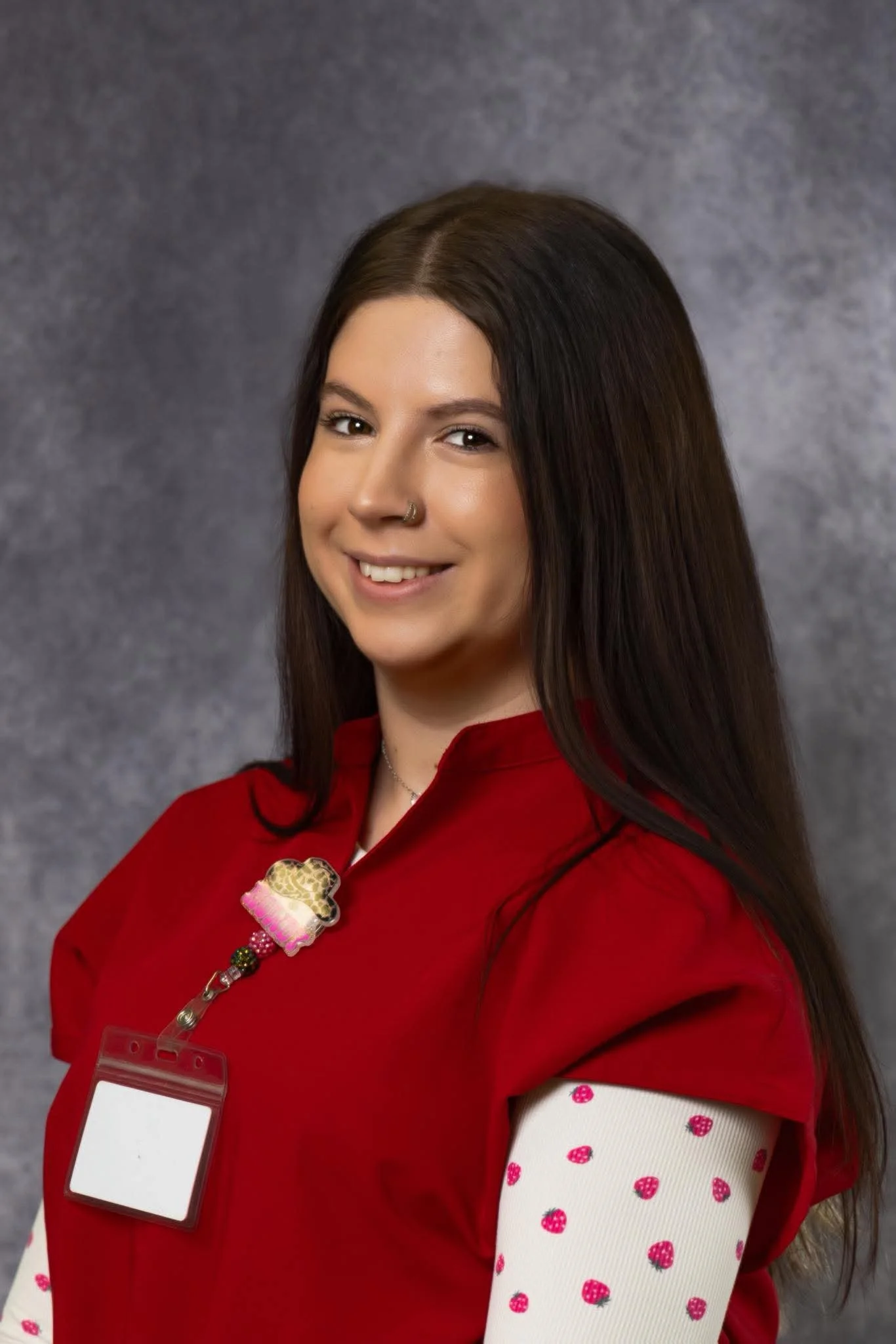 A professional portrait of a female nurse smiling.