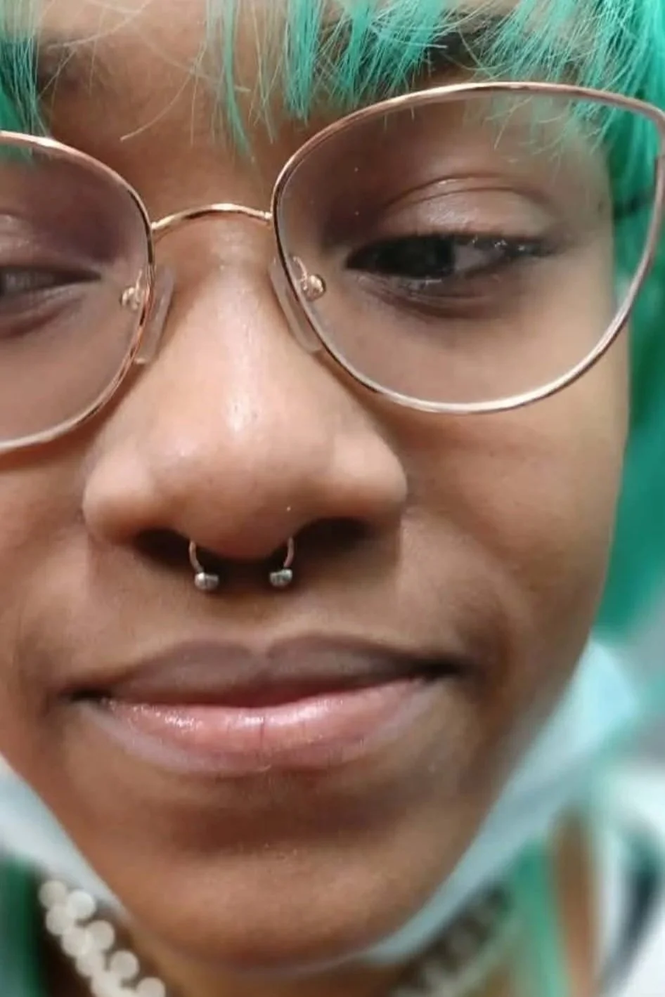 A close view of a woman's new septum piercing.